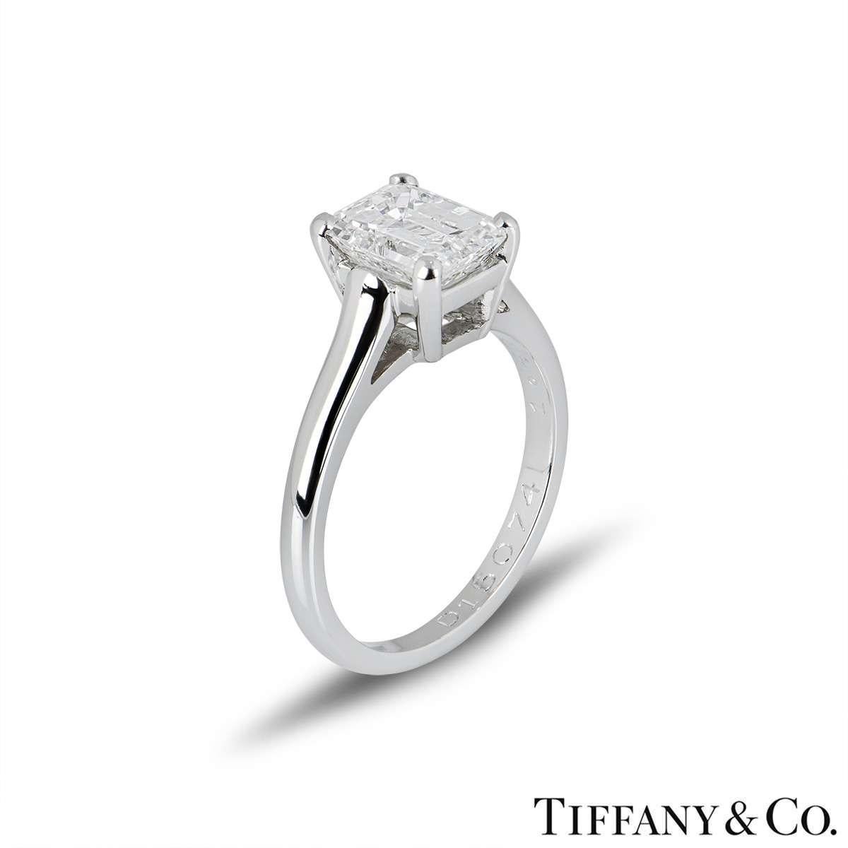 A stunning emerald cut diamond single stone ring in platinum by Tiffany & Co. The ring is set to the centre with a 1.59ct emerald cut diamond, E colour and VS1 in clarity, set within a four claw setting. The ring is currently a size UK J½ - EU 49 -