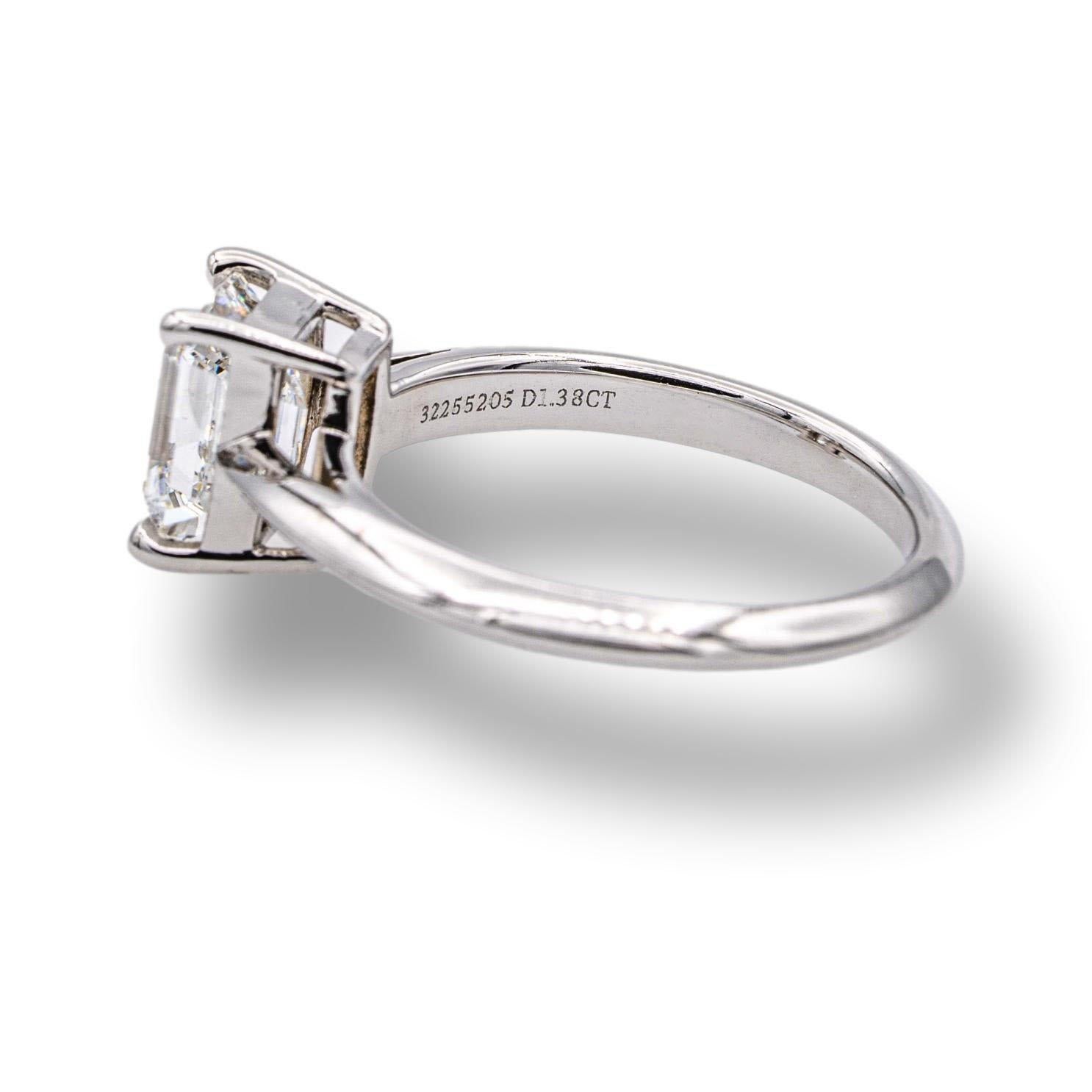 Tiffany & Co. engagement ring finely crafted in platinum with an Emerald cut diamond center weighing 1.38 carats F color VVS2 clarity. The diamond is set in a four prong basket setting with a knife edge open-gallery shank, fully hallmarked with