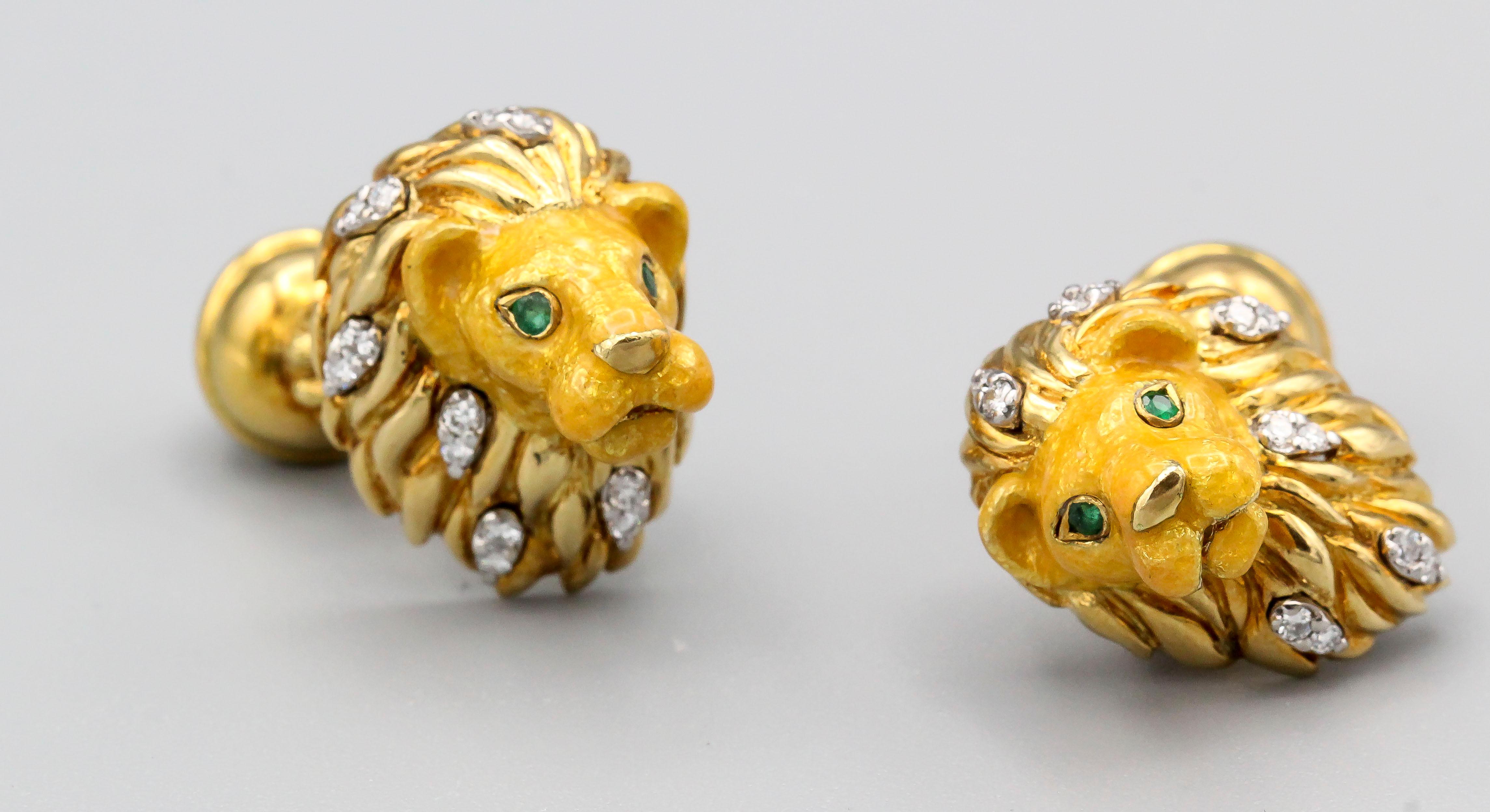 Handsome 18K yellow gold cufflinks by Tiffany & Co. They resemble a lion heads with round cut emerald eyes, diamonds in the mane, enameled face, and the opposite end with a paw on top of a sphere coming out of the back. 

Hallmarks: Tiffany & Co.