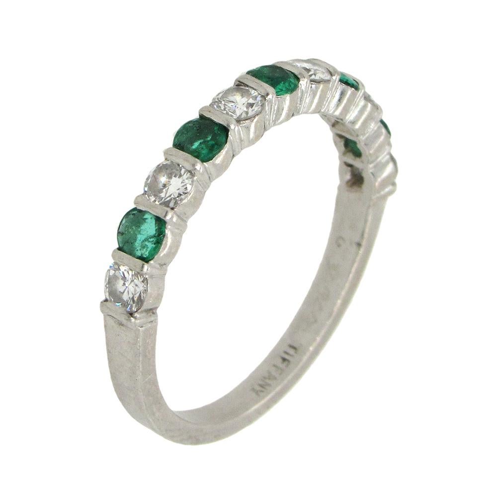 Classic Tiffany & Co half-eternity band set with alternating 6 round brilliant diamonds and 5 round emeralds in platinum, 3.5mm wide and size 6.