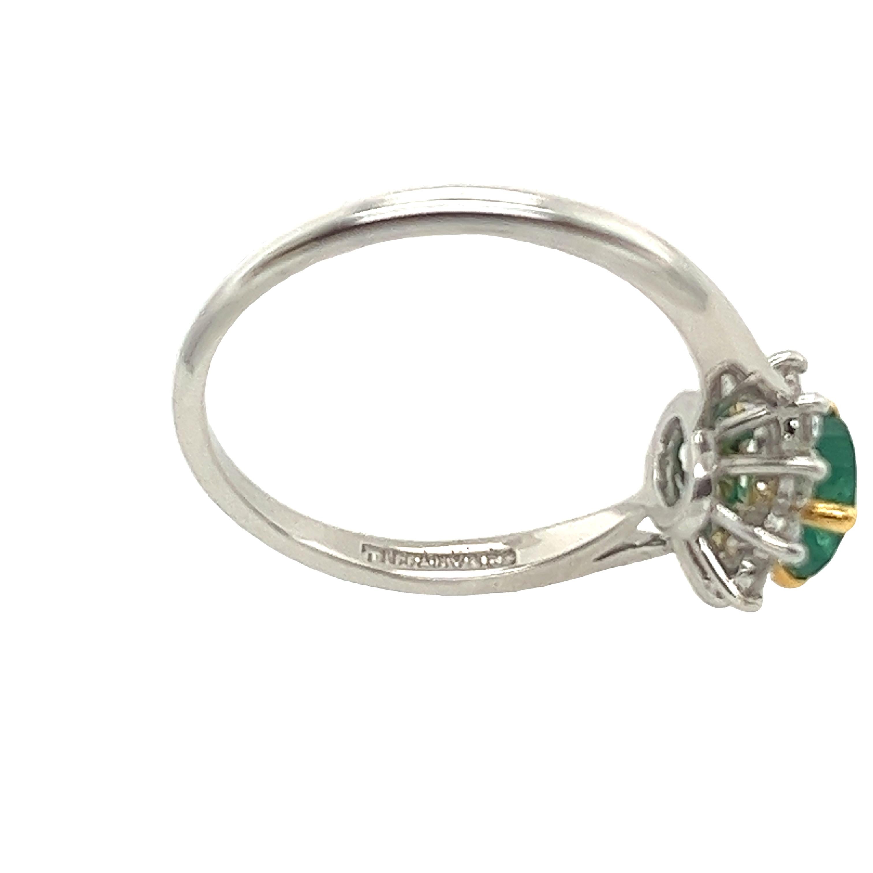 Discover the enchanting beauty of the Tiffany & Co. Emerald and Diamond Cluster Ring. Set in a luxurious blend of platinum and 18-carat yellow gold, this captivating piece features a stunning cluster of emeralds and diamonds. Each gemstone is