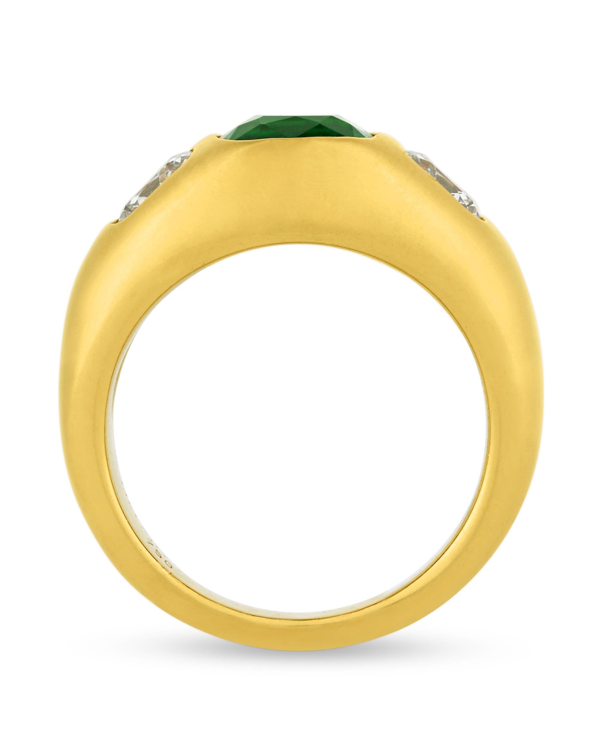 Displaying a striking vivid green color, an approximately 1.90-carat antique cushion-cut emerald lies at the center of this domed ring. This gemstone is certified by the Swiss Gemmological Institute as being Zambian in origin, with no indications of