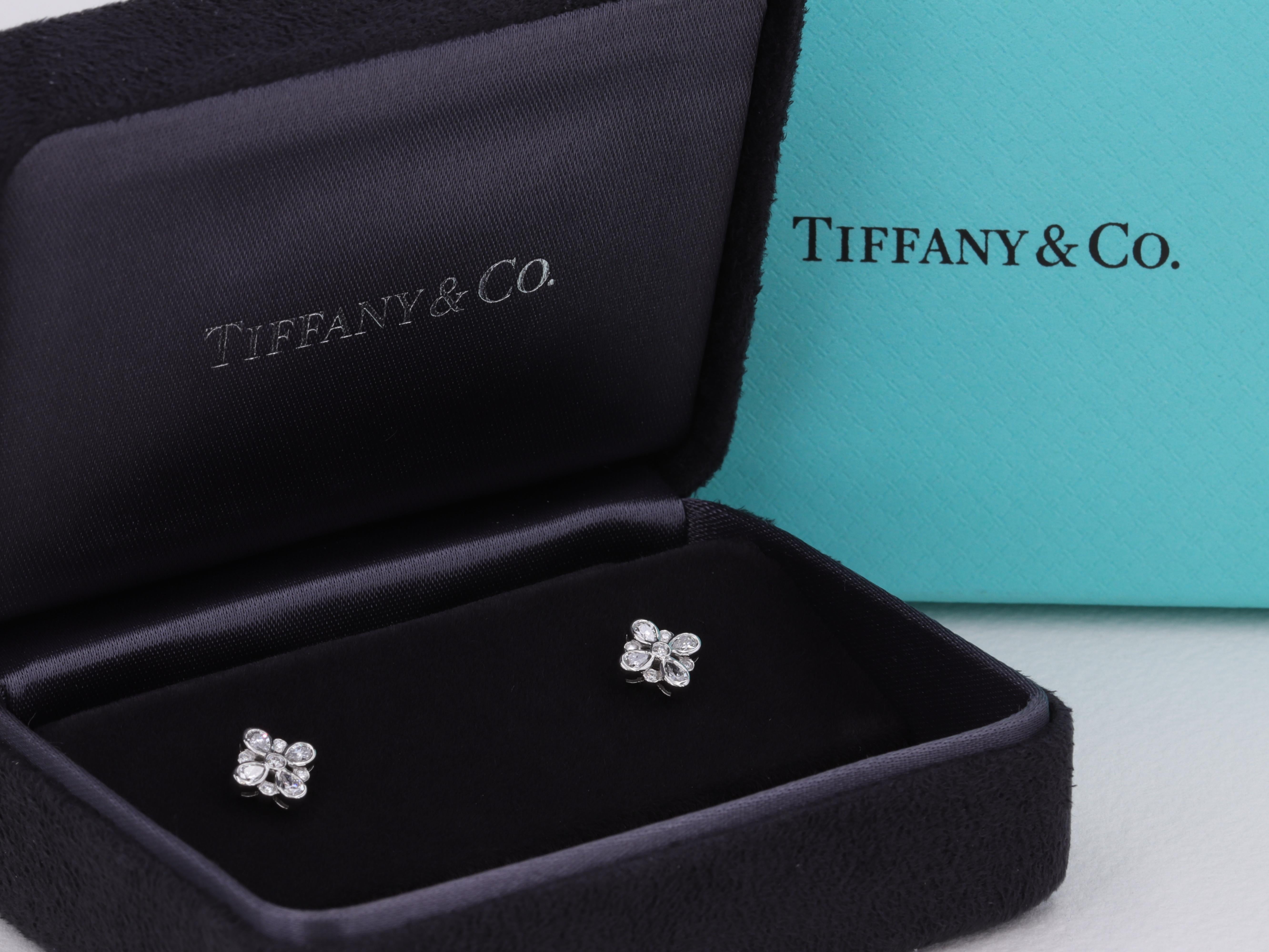 Tiffany & Co. Enchant collection diamond and platinum floral motif earrings featuring . 35 carats of pear shape and round brilliant cut diamonds of E-G color and VS+ clarity.

The earrings feature 