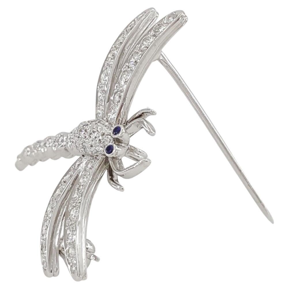 Tiffany & Co. Enchant® Platinum 0.56 ct Round Cut Diamond & Blue Sapphire Dragonfly Brooch / Pin. The brooch weighs 5.3 grams.