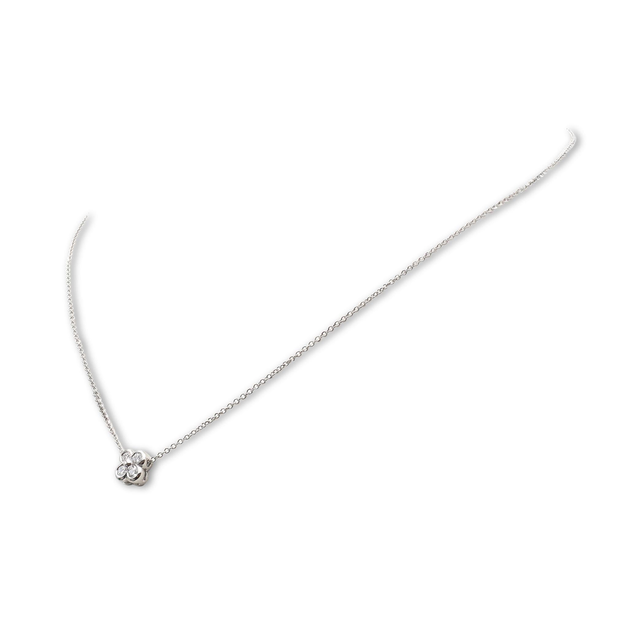 Authentic Tiffany & Co. necklace from the 'Enchant' collection crafted in platinum and featuring a flower pendant set with 4 glittering round brilliant diamonds for an estimated 0.28 carats total weight.  The pendant hangs from a delicate 16-inch