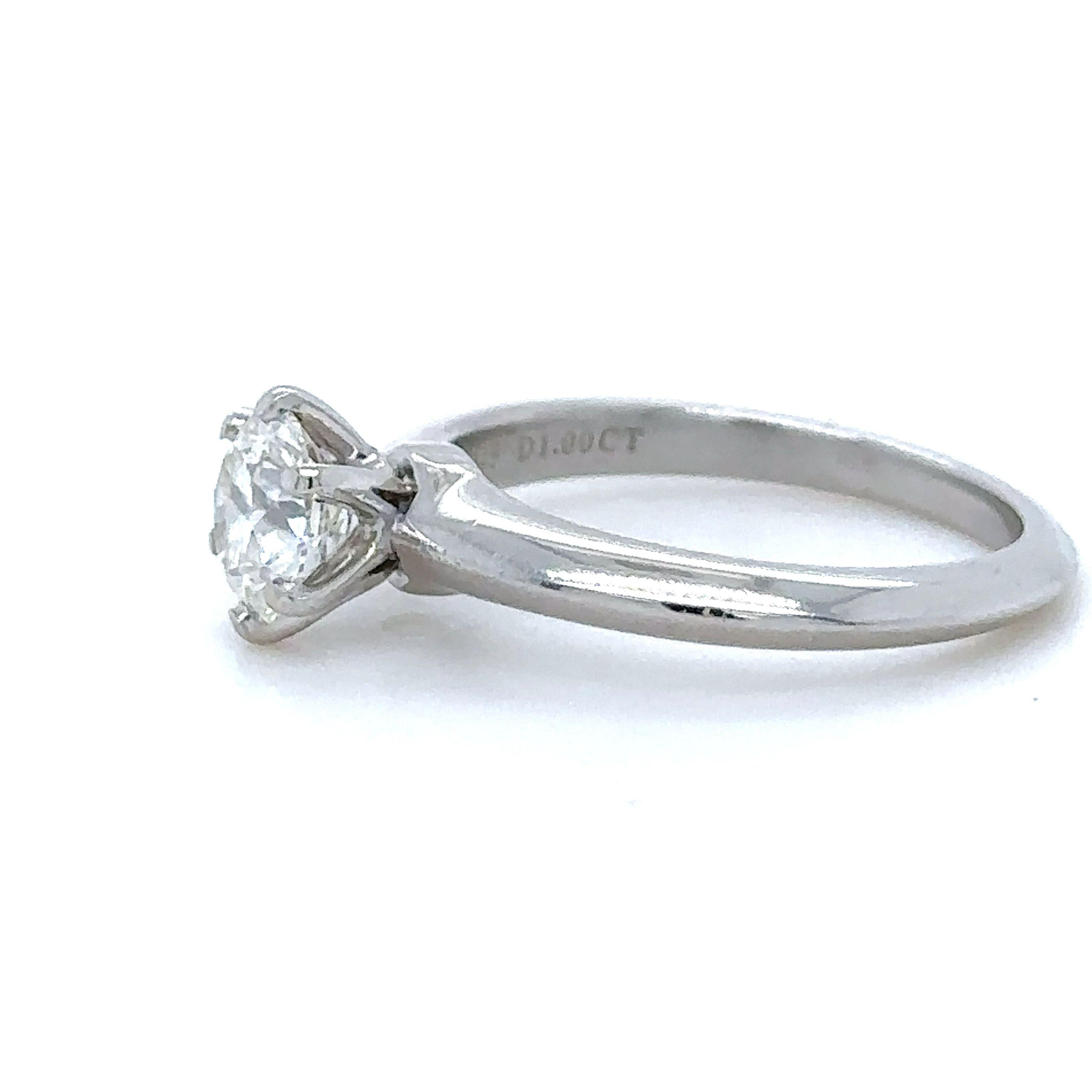 A Tiffany & Co, Diamond Engagement Ring, made of 950 Platinum, and weighing 5.84 gm. Stamped: Tiffany & Co. PT950 30297245.

Set with a Round, brilliant cut Diamond, colour I, and clarity VS2. Weighing 1.00 ct. laser inscribed: T&Co. N08010008.
