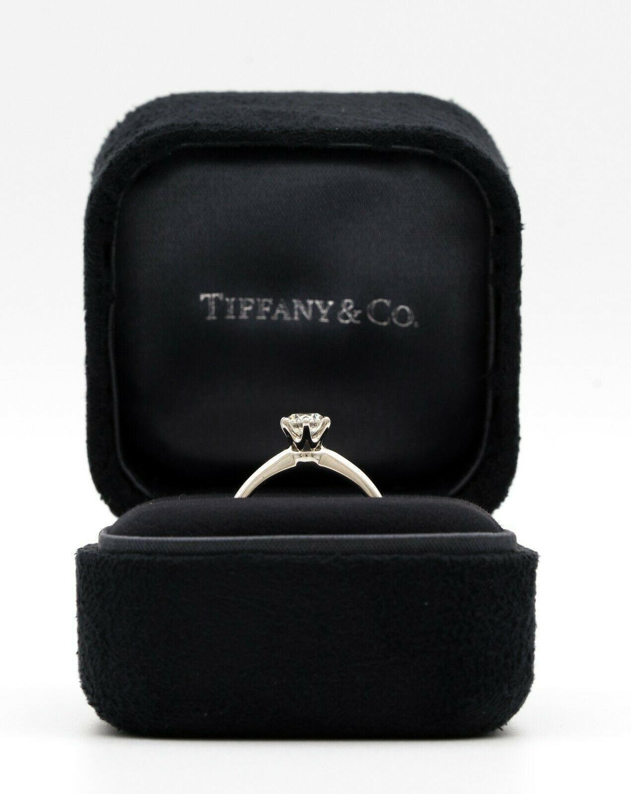 Tiffany & Co. Diamond Engagement ring with Tiffany & Co. Hallmark, featuring a .46 ct Center, graded H color , and VVS1 Clarity, in Platinum.
Crown Inscription: T&Co. 012130441
Signed: Tiffany & Co
Stamped: 32847064 , D.046CT, PT950
Includes