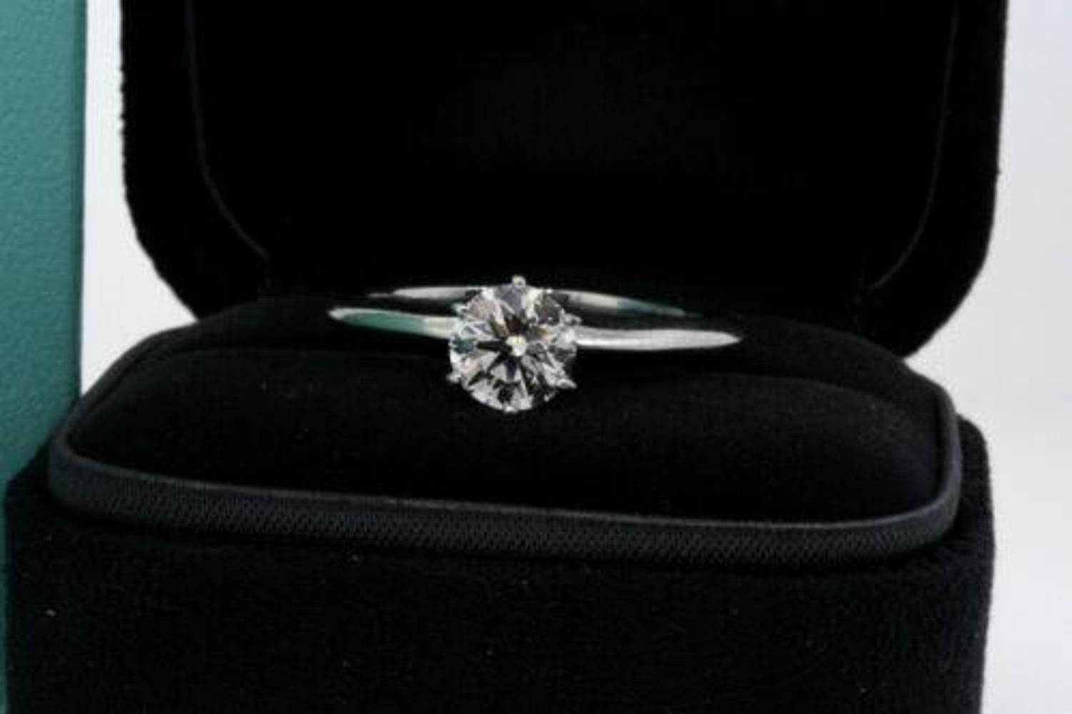 Here we have a Tiffany & Co. .96 carat I VVS1 round brilliant diamond solitaire engagement ring in platinum size 8. Although there is no paperwork for the ring, the serial number is engraved on a crown facet of the diamond, and the quality has been