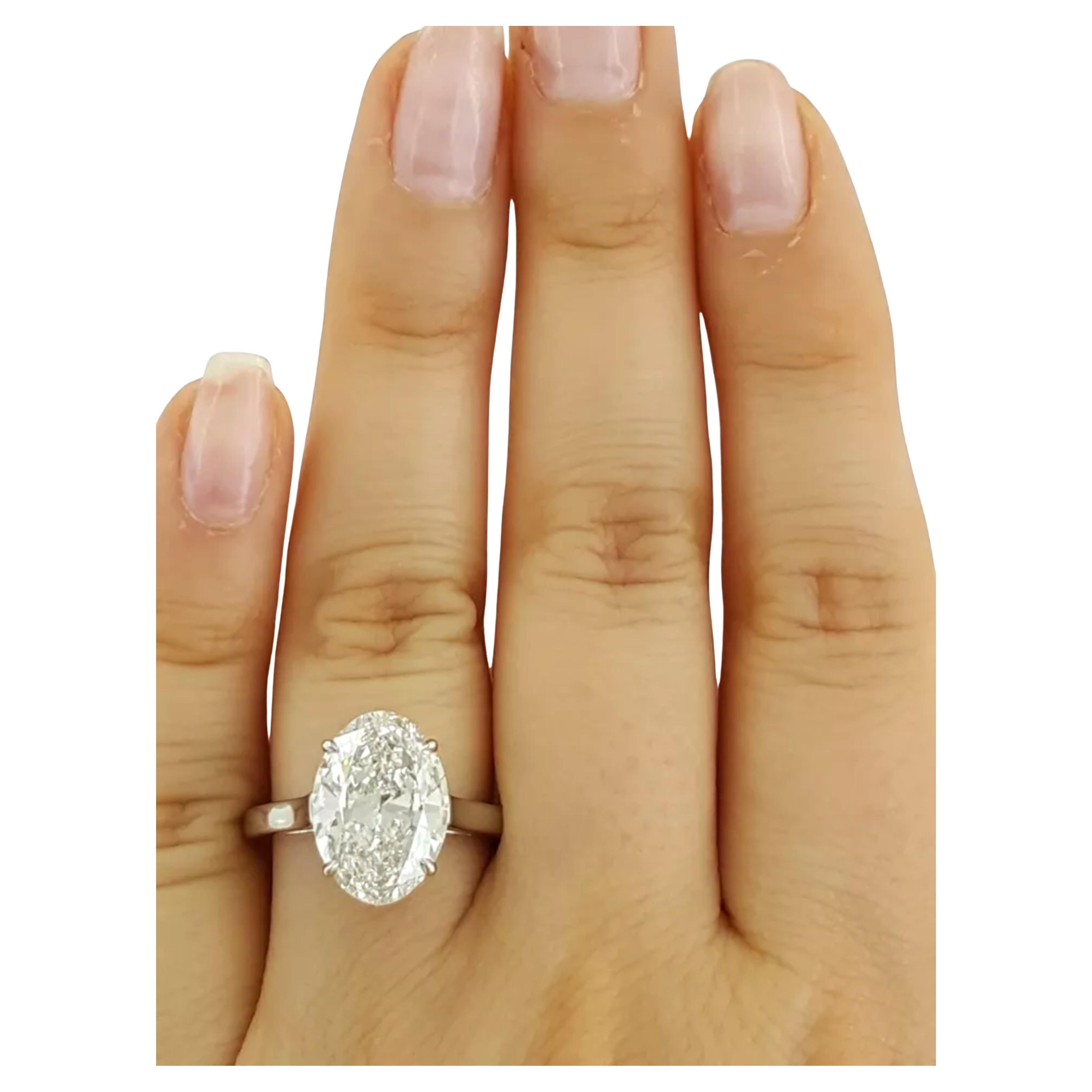 Round Cut Tiffany & Co. engagement ring featuring an impressive 5.01 ct oval cut diamond For Sale