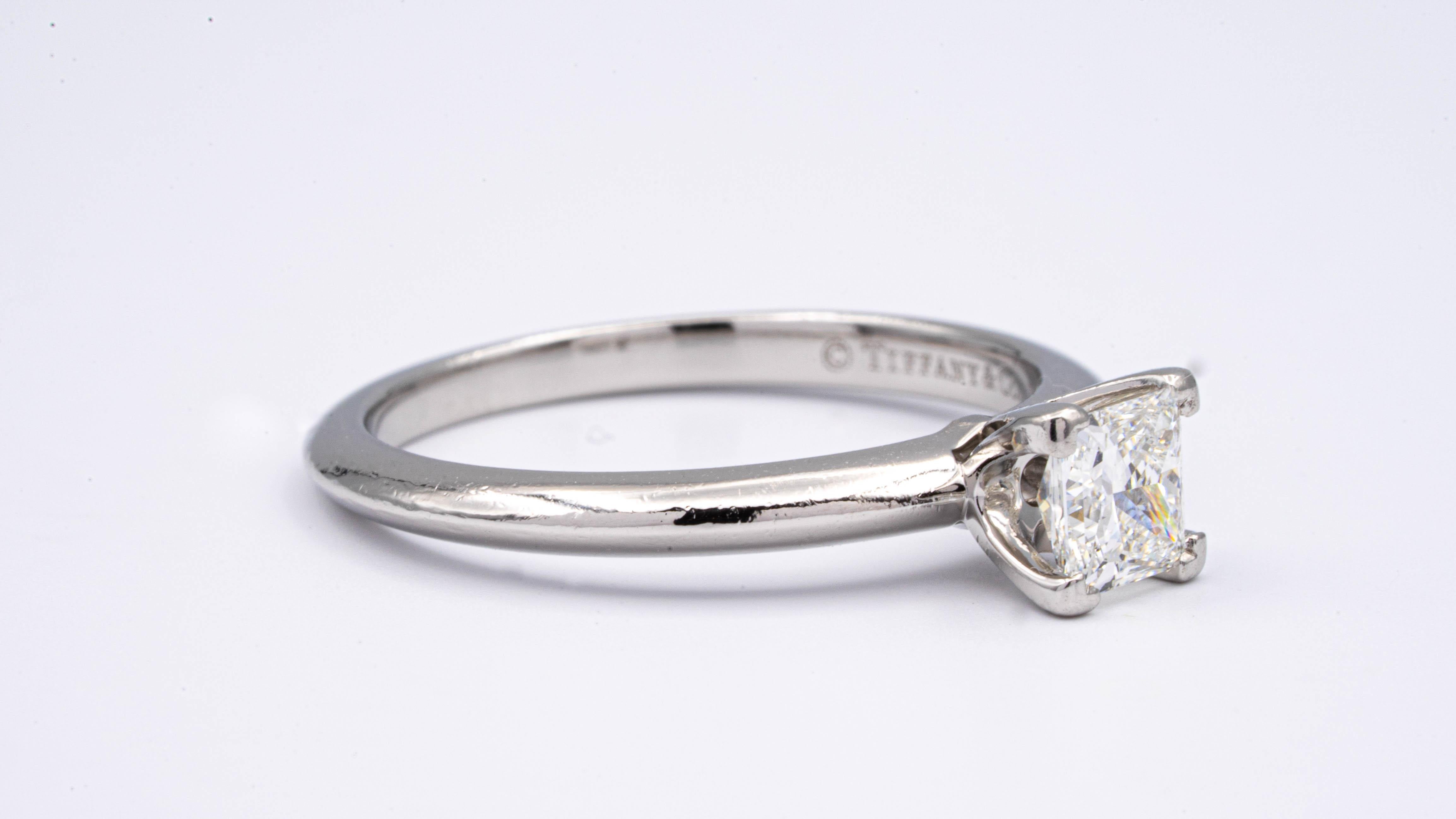 Classic Diamond Engagement Solitaire ring signed by Tiffany & Co. finely crafted in platinum featuring a 4 prong set 0.51 carat  Center princess cut diamond graded by Tiffany H color , and fine VVS1 Clarity. 

Stamped: Tiffany & Co. PT 950 