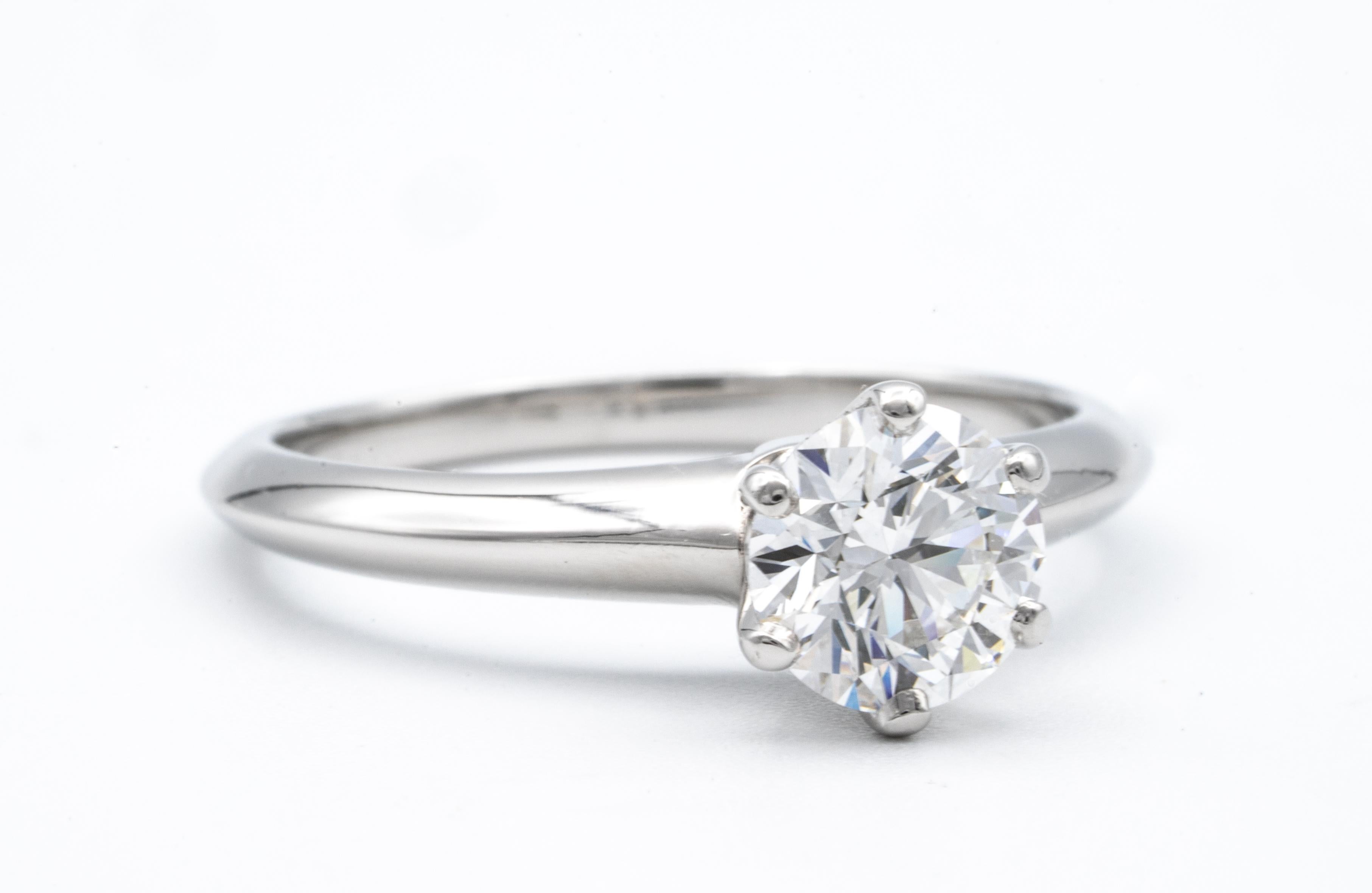 Tiffany & Co. Diamond Engagement Solitaire signed by Tiffany & Co. featuring a .92 ct Center, graded F color , and VS1 Clarity.
In Platinum

Crown Inscription: T&Co. 19263363
Includes Original Tiffany Certificate and Box
Current Retail from Tiffany