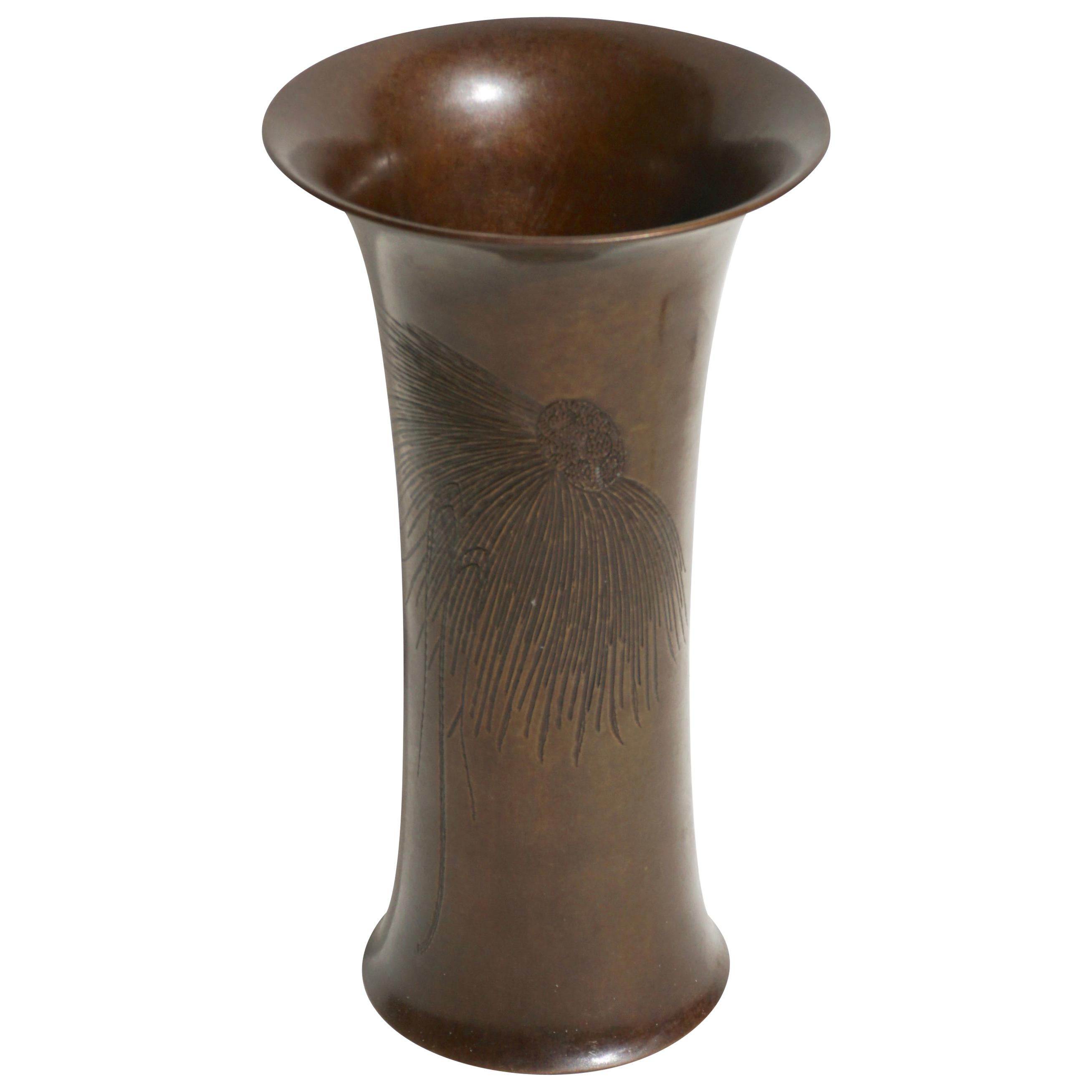 A stunning “TSNY” patinated brown bronze cylindrical tapered vase engraved with an Art Nouveau or Art Deco motif of a Black Eyed Susan flower, circa 1910. A beautiful hand chased vase similar to Tiffany Studios New York bronze works.

Marked on base