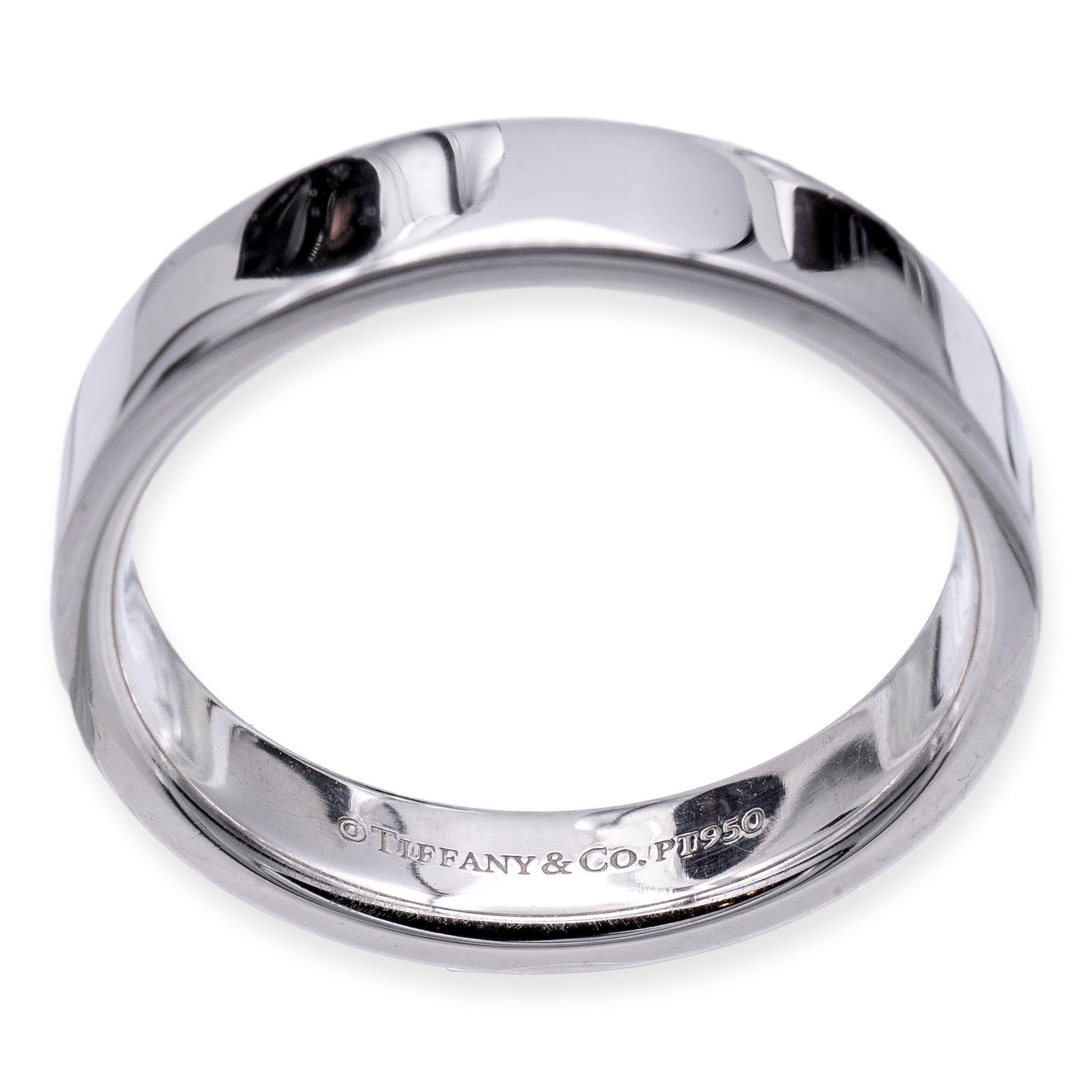 Tiffany & Co. 4mm wedding band ring finely crafted in platinum featuring sleek flat edges. 
Fully hallmarked with Tiffany logo and metal content. 

Ring Specifications
Brand: Tiffany & Co.
Style: Essential Band
Hallmarks: ©Tiffany & Co. PT950
Finger