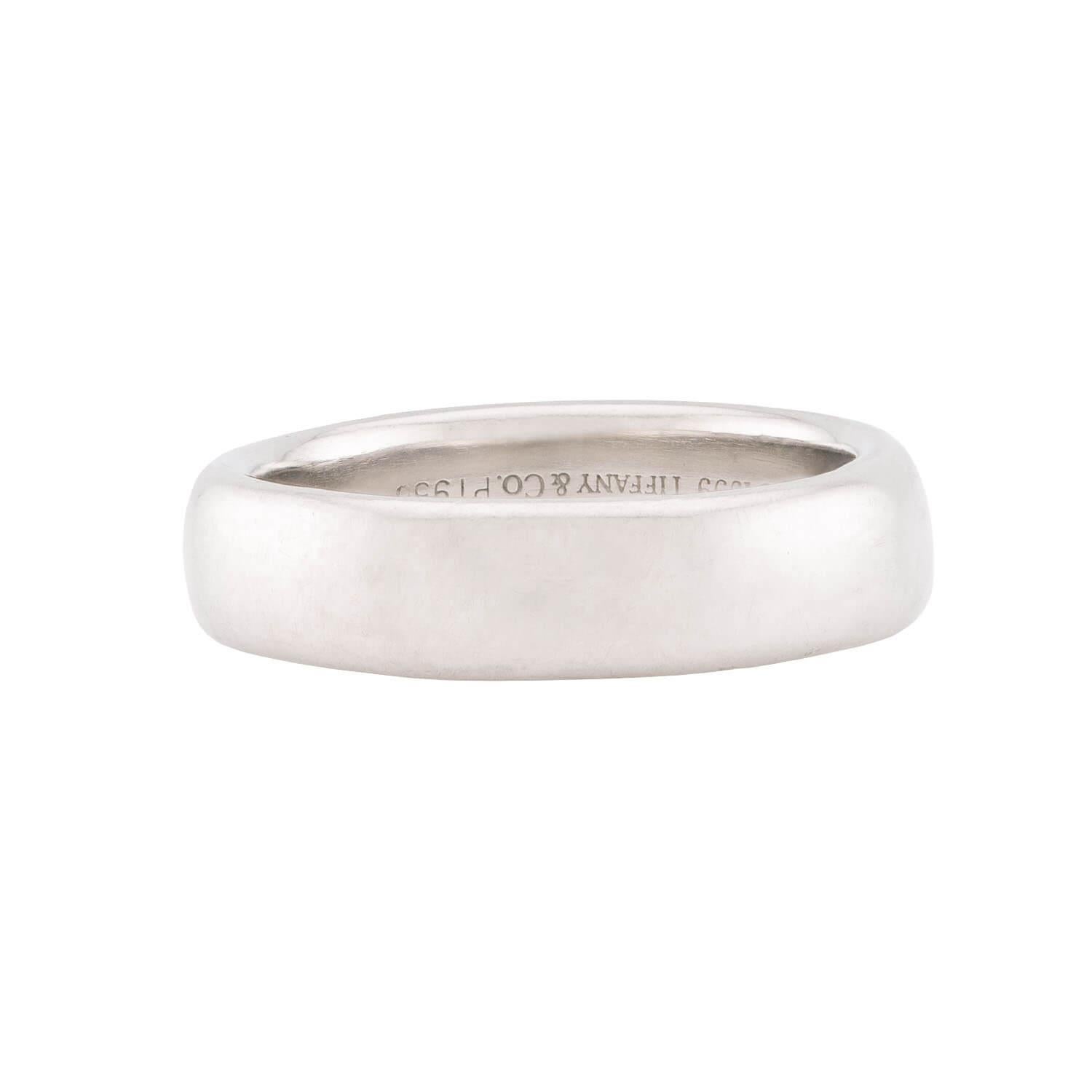 A simple and classic ring from the iconic jewelry maker Tiffany & Co.! This lovely piece is crafted in platinum and forms a thin but substantial band that is smoothly polished all the way around. The understated and simple design looks wonderful