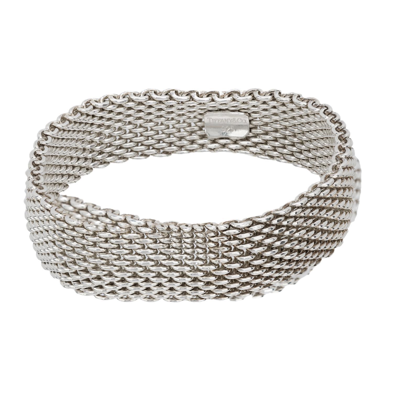 A fabulous bracelet from legendary jeweler Tiffany & Co.! This stylish piece is crafted in sterling silver and is formed by a series of interlocking links which create a stylish mesh-like base. The flexible bracelet wraps comfortably around the