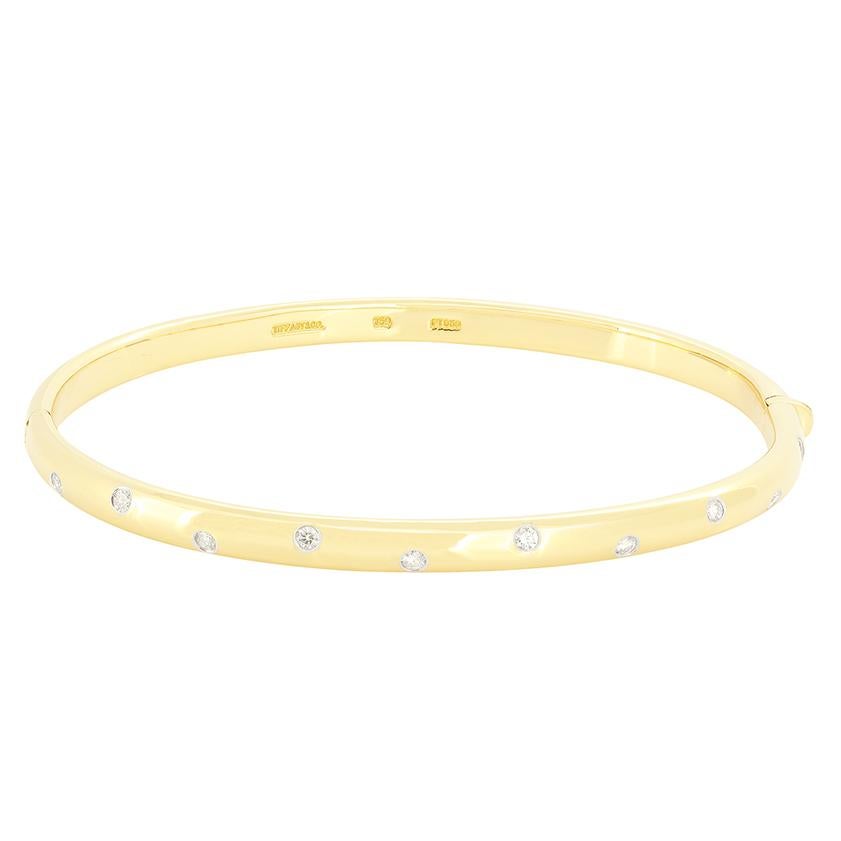 This beautiful bangle comes from Tiffany & Co’s ‘Etoile’ collection. It is set with ten round brilliant cut diamonds, totalling to 0.30 carat around its circumference. The diamonds have been set within platinum bezels and the remainder of the Bangle