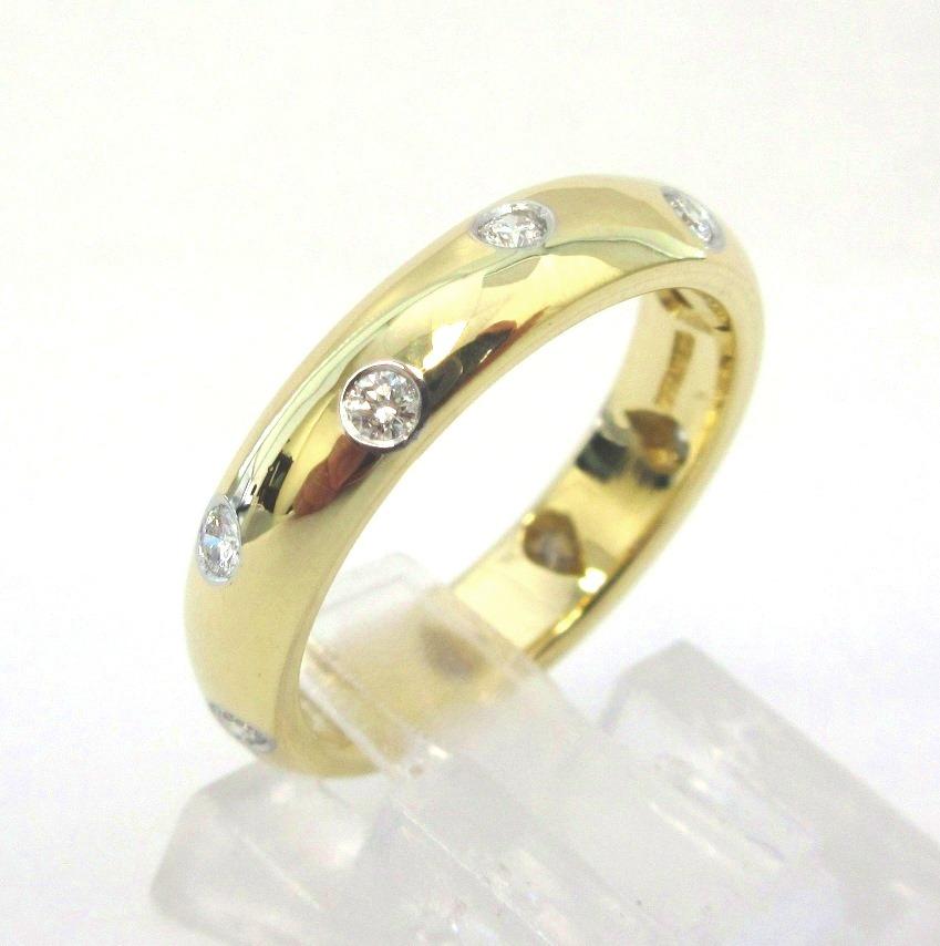 TIFFANY & Co. 18K Gold Diamond Etoile 4mm Band Ring 6

Metal: 18K Gold
Size: 6
Band Width: 4mm
Diamond: 10 round brilliant diamonds, carat total weight .22
Hallmark: TIFFANY&CO. 750 PT950 
Condition: Excellent condition, like new, comes with Tiffany