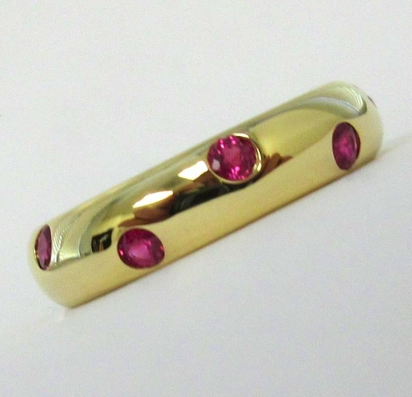  TIFFANY & Co. Etoile 18K Gold Ruby Band Ring 4.5

Metal: 18K Yellow Gold 
Size: 4.5
Band Width: 4mm
Weight: 4.50 grams
Ruby: 10 round rubies, carat total weight .25 
Hallmark: TIFFANY&CO. 750 

Limited edition, no longer available for sale in