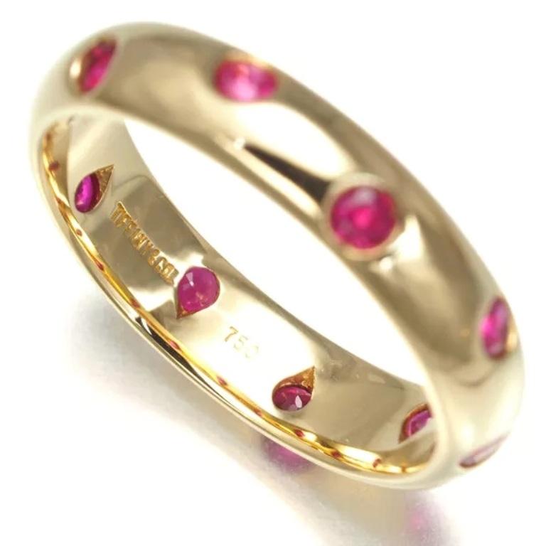 TIFFANY & Co. Etoile 18K Gold Ruby Band Ring 5.5

Metal: 18K Gold 
Size: 5.5
Band Width: 4mm
Ruby: 10 round rubies, carat total weight .25 
Hallmark: TIFFANY&CO. 750 
Condition: Excellent condition, like new, comes with Tiffany pouch and