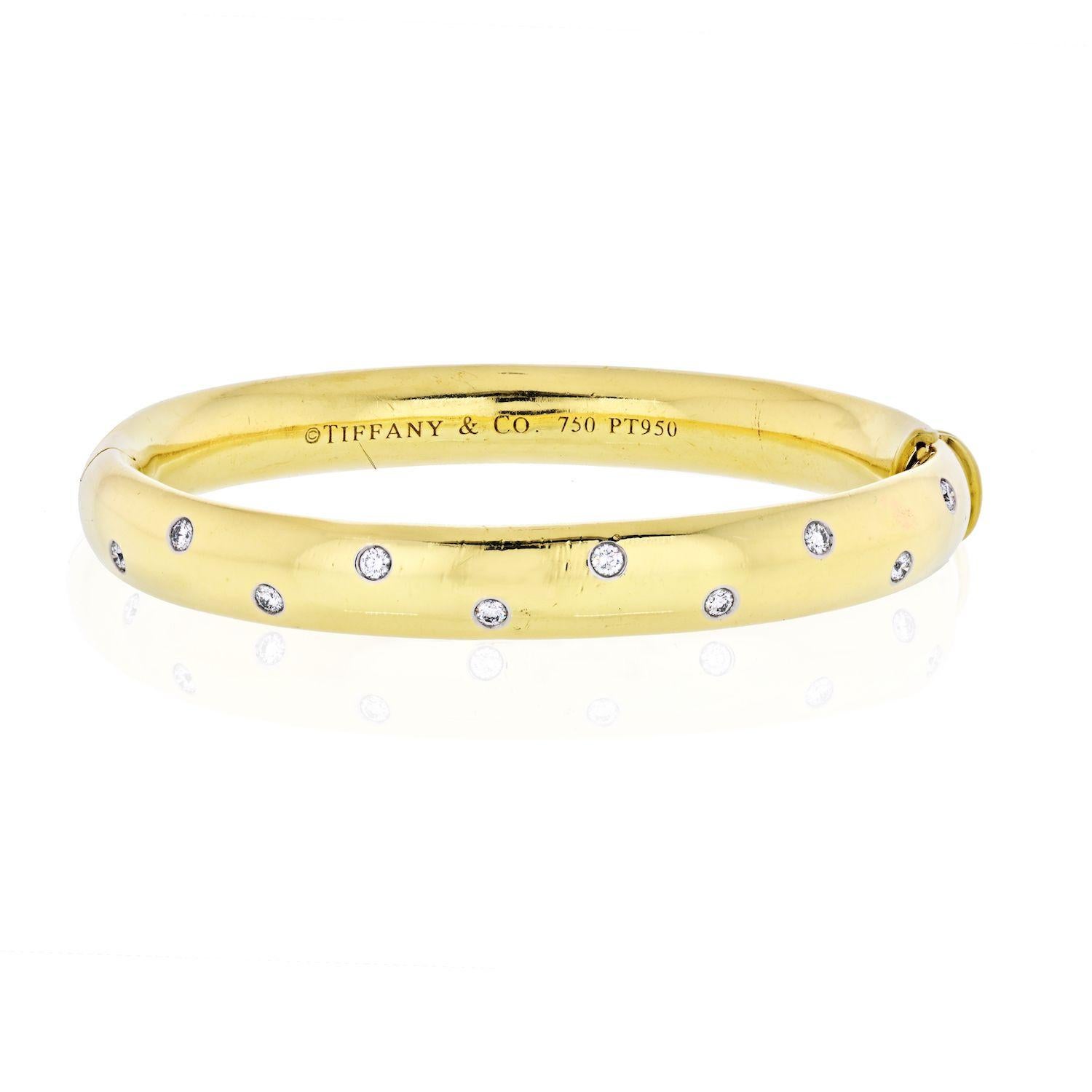 Tiffany & Co. Etoile 18K Yellow Gold Diamond Bangle Bracelet

This Tiffany & Co. Etoile bangle with 10 round cut diamonds, is in absolutely perfect condition, having recently been re-polished by our specialist craftsmen.

Sparkling G/VS diamonds sit