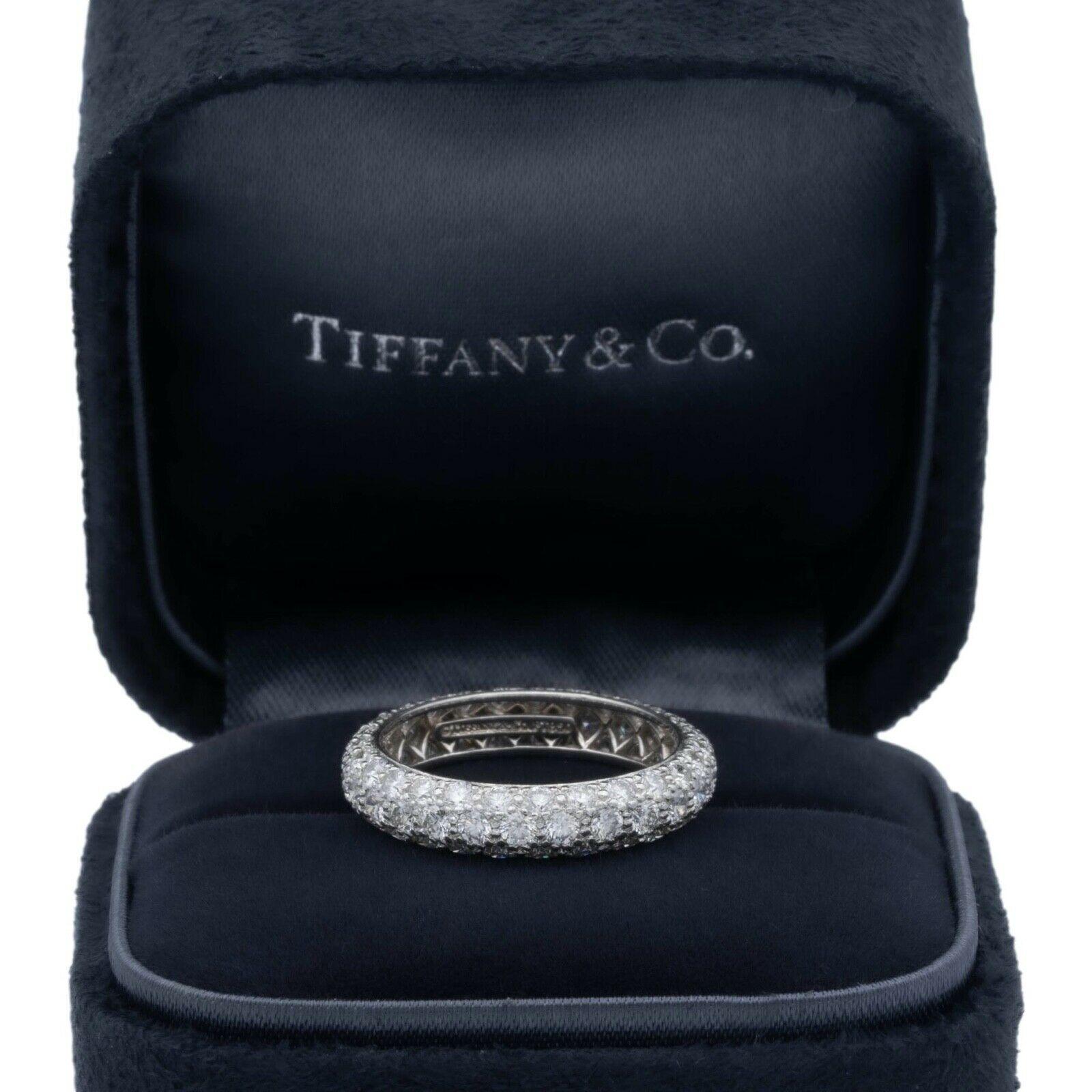 Tiffany & Co. 3 row pave band ring from the Etoile collection finely crafted in platinum with 81 round brilliant cut diamonds bead set all the way around weighing 1.51 carats total weight, E-F color , VS1-VS2 clarity. The band has a domed design