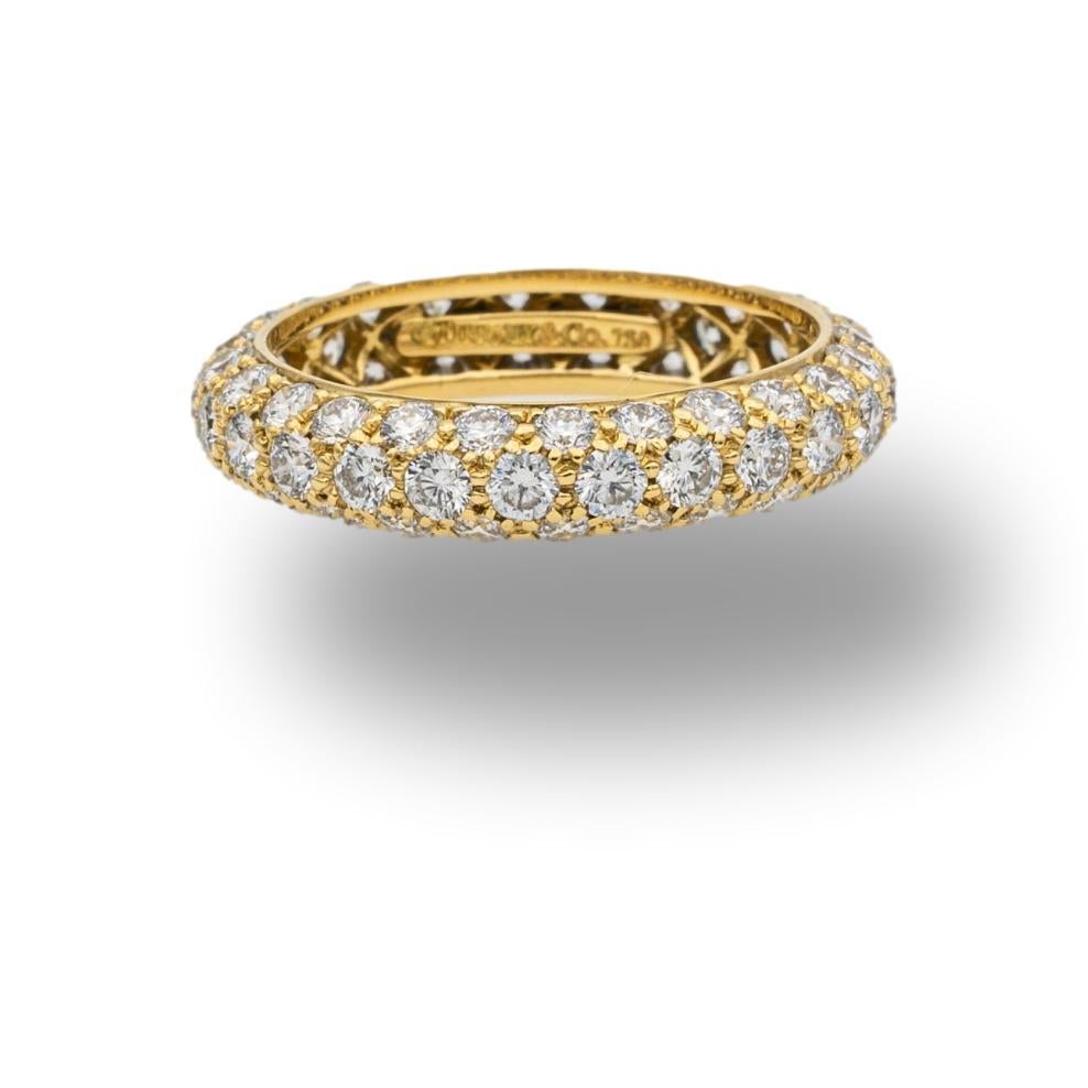 Tiffany & Co. Diamond Band ring from the Etoile collection finely crafted in 18 karat yellow gold with 3 rows of pave set round brilliant cut diamonds weighing 1.70 carats total weight , G color VS clarity. Accompanied by Tiffany Appraisal.

Stamp: