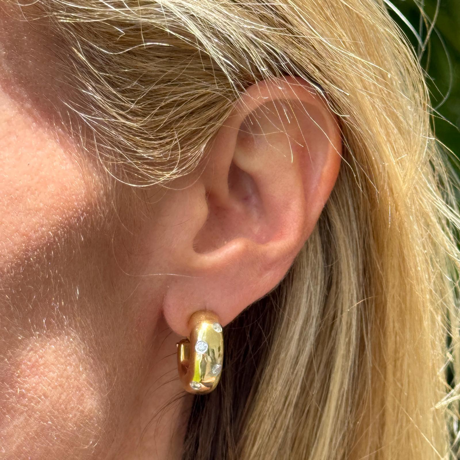 These elegant Tiffany & Co. Etoile earrings are crafted from 18 karat yellow gold with platinum settings, showcasing approximately 0.50 carats total weight of round brilliant diamonds. The diamonds are graded F-G color and VS clarity, offering