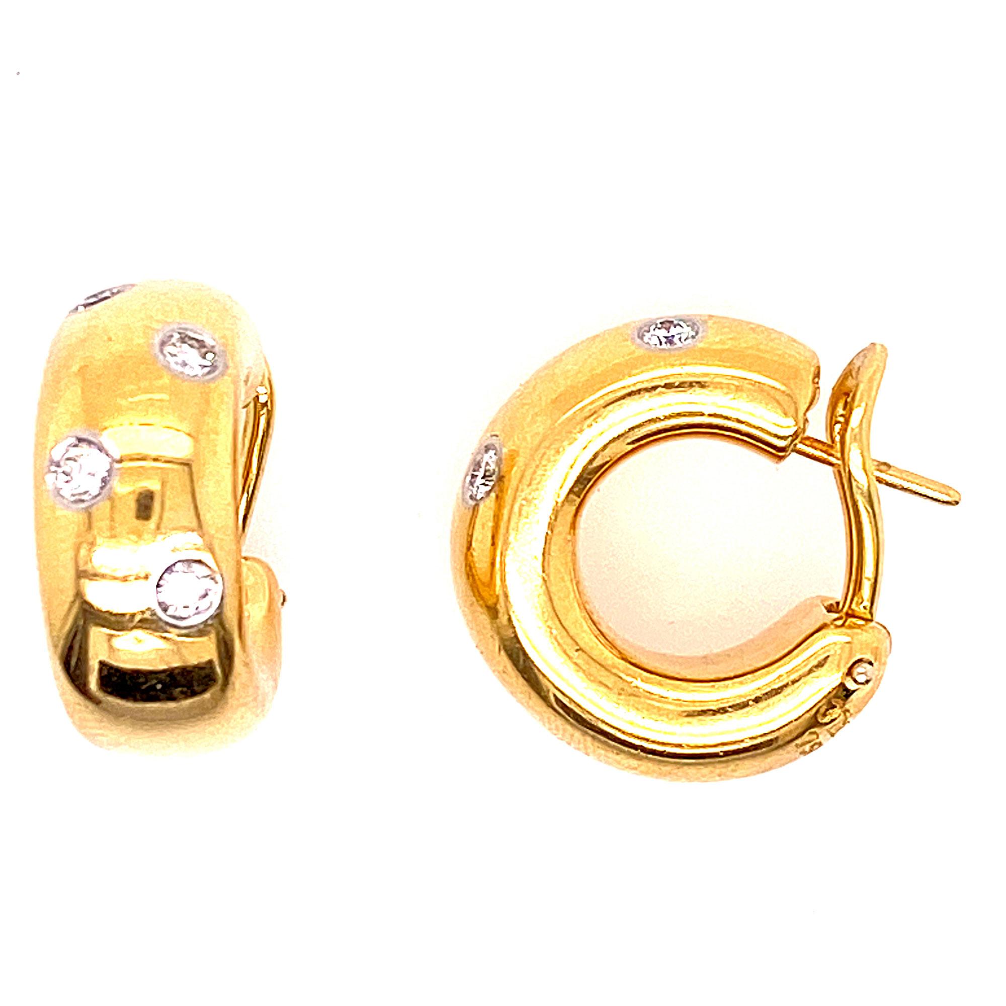 18K yellow gold Tiffany & Co. Etoile huggie hoop earrings featuring platinum bezel set 0.40 carats of round brilliant cut diamonds and omega back closures. The earrings measure approximately 15 x 20mm and are signed Tiffany & Co 750 PT950. 