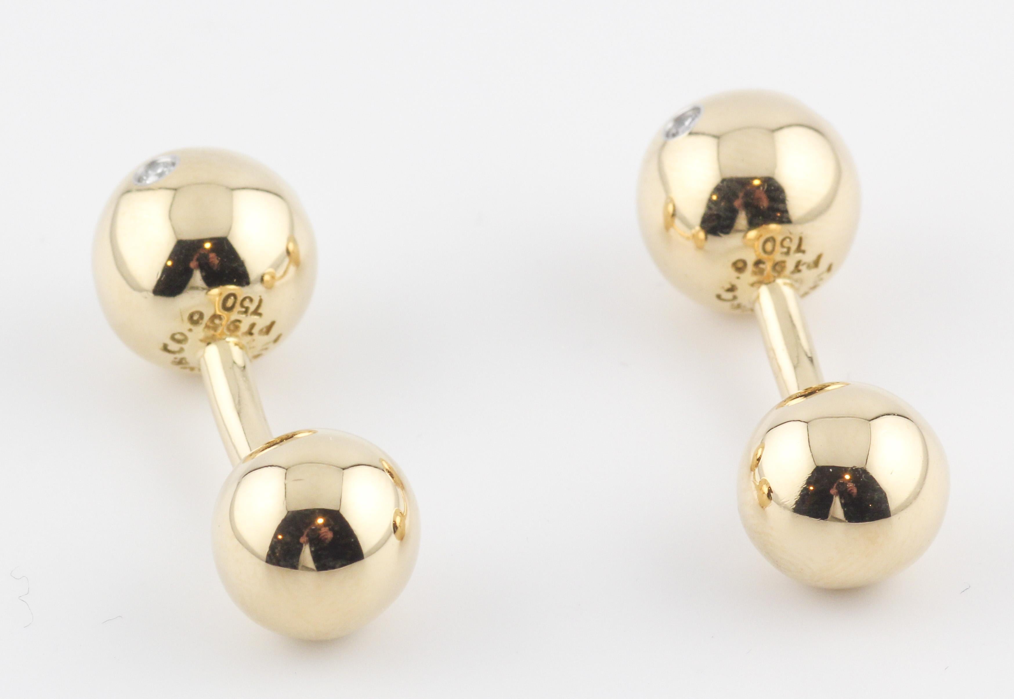 Step into a world of refined elegance with these Tiffany & Co. Etoile Diamond 18K Gold Platinum Dumbbell Cufflinks. Melding the iconic craftsmanship of Tiffany & Co. with a sophisticated design, these cufflinks are a testament to the brand's