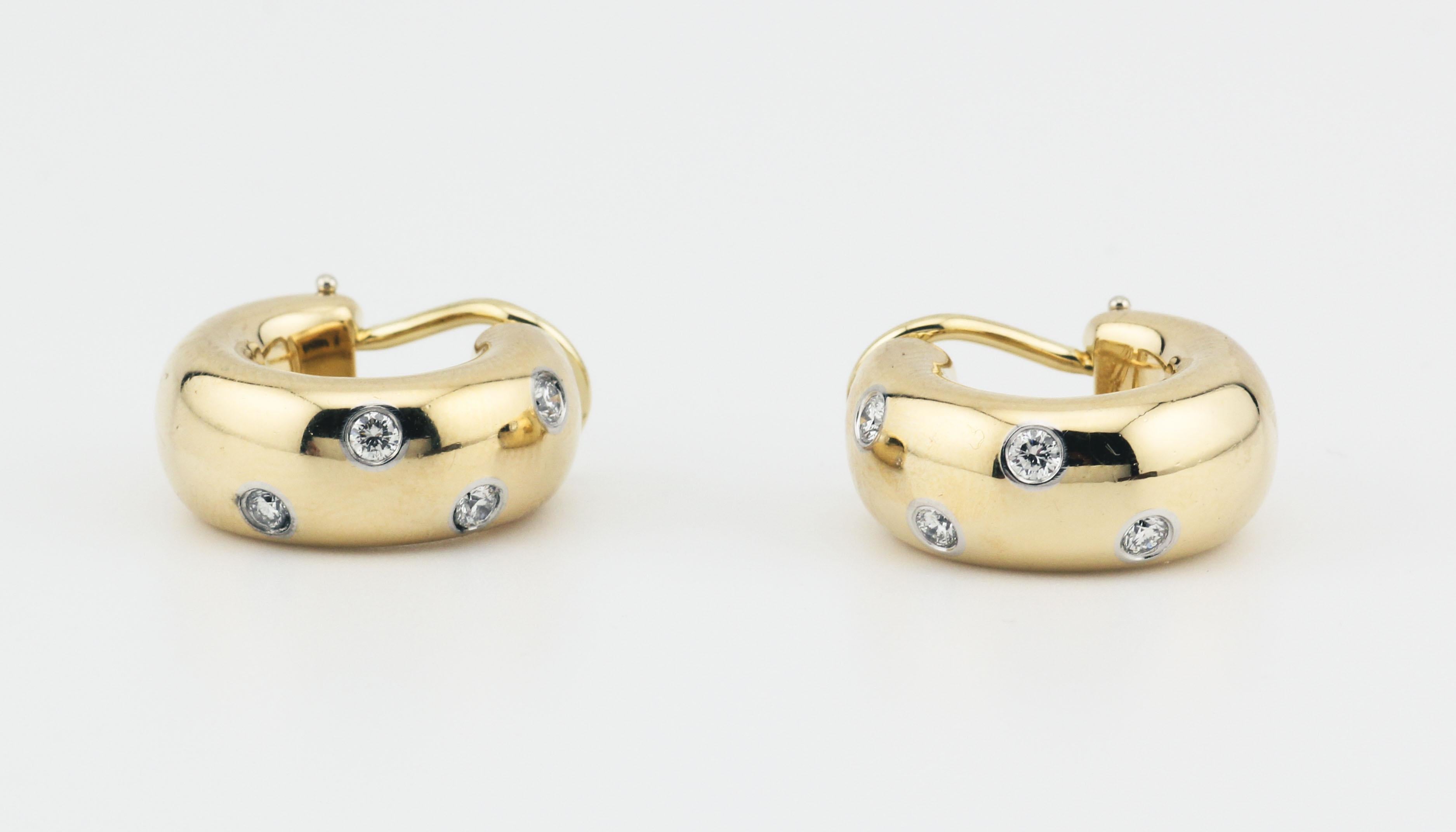 Indulge in the epitome of sophistication and brilliance with the Tiffany & Co. Etoile Diamond 18k Gold Platinum Wide Hoop Earrings. Crafted by the iconic American luxury jeweler, these earrings are a dazzling fusion of exquisite design, premium