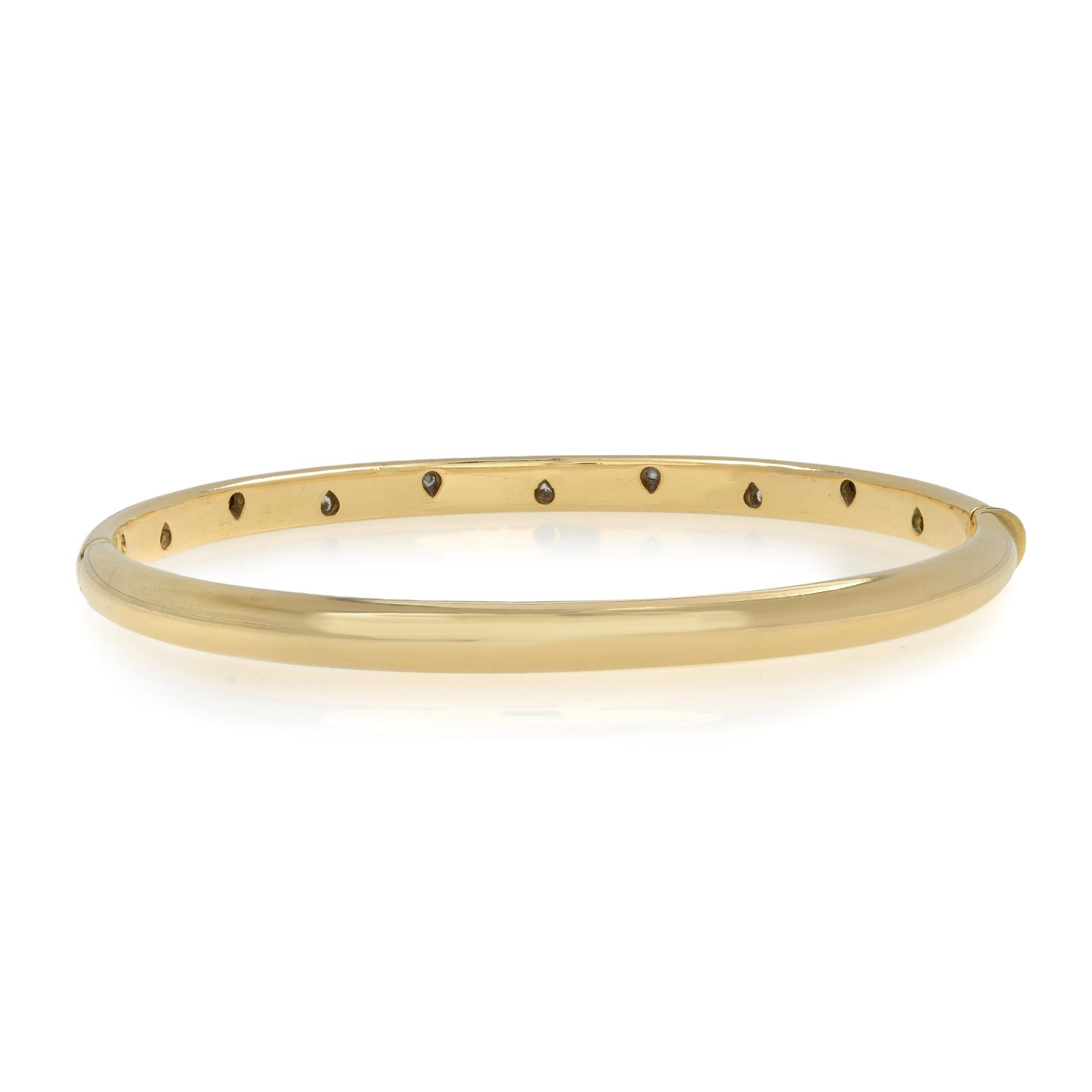 Simple and modern, the designs of the Etoile collection are elegantly punctuated with brilliant diamonds. This elegant bangle is a timeless finishing touch to any look. Crafted in 18k yellow gold. Bezel set with round cut diamonds. Total carat