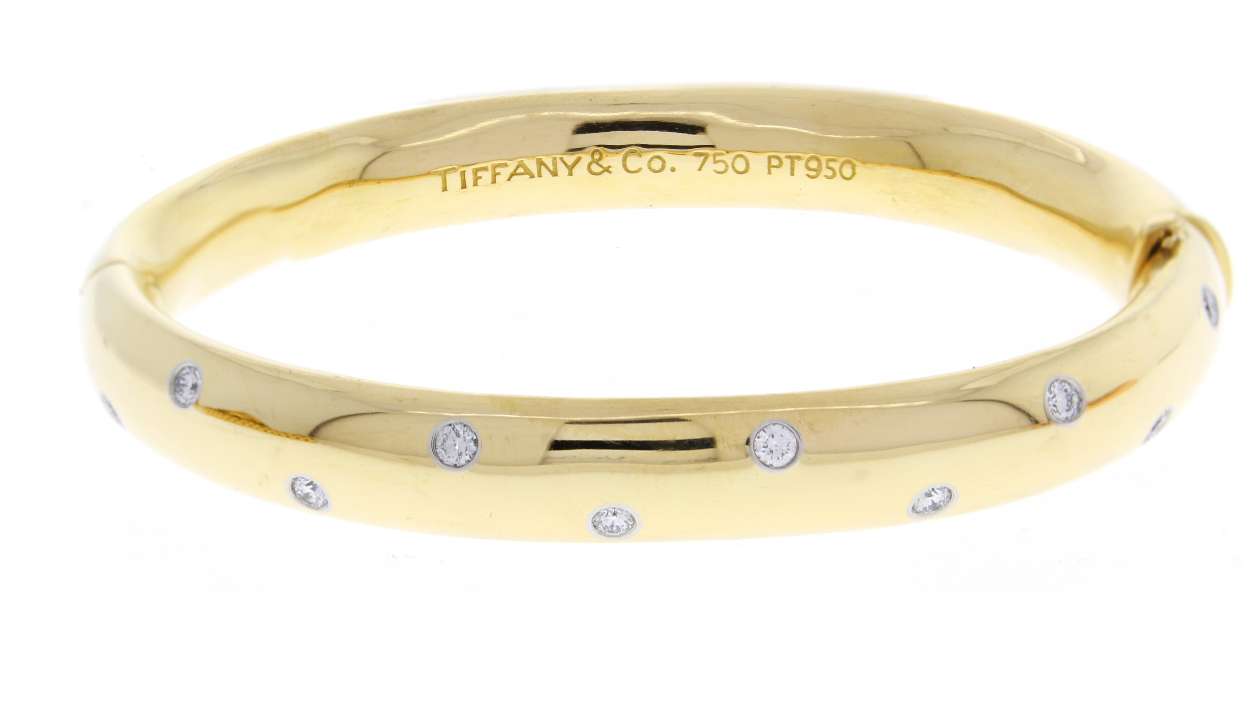 From Tiffany & Co.'s Etoile collect, their wide diamond Etoile bangle
♦ Designer: Tiffany & Co.
♦ Metal: 18 karat and platinum
♦ 10 brilliant diamonds=.50 carats, set in platinum
♦ Circa 2000
♦ Size Medium, 10mm wide
♦ Size 63 gram 
♦ Packaging: