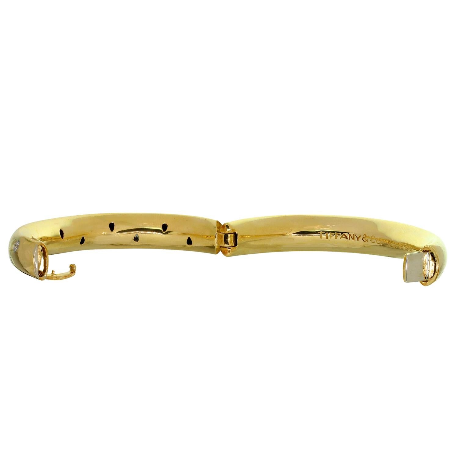 This gorgeous Tiffany & Co. small model bangle bracelet from the classic Etoile collection inspired by starry skies is crafted in 18k yellow gold with 950 platinum accents and set with 10 brilliant-cut round E-F VVS2-VS1 diamonds weighing an