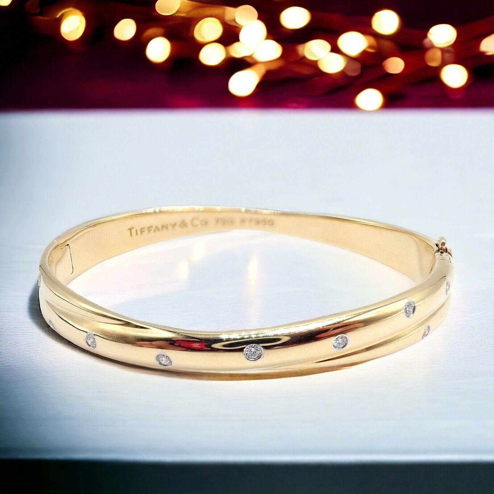 Platinum And 18k Yellow Gold Diamond Etiole Crossover Bangle Bracelet by Tiffany & Co.  
The Tiffany & Co 18k Yellow Gold Platinum Etoile Diamond Crossover Bangle Bracelet is a luxurious and elegant piece of jewelry. 
Crafted from high-quality gold