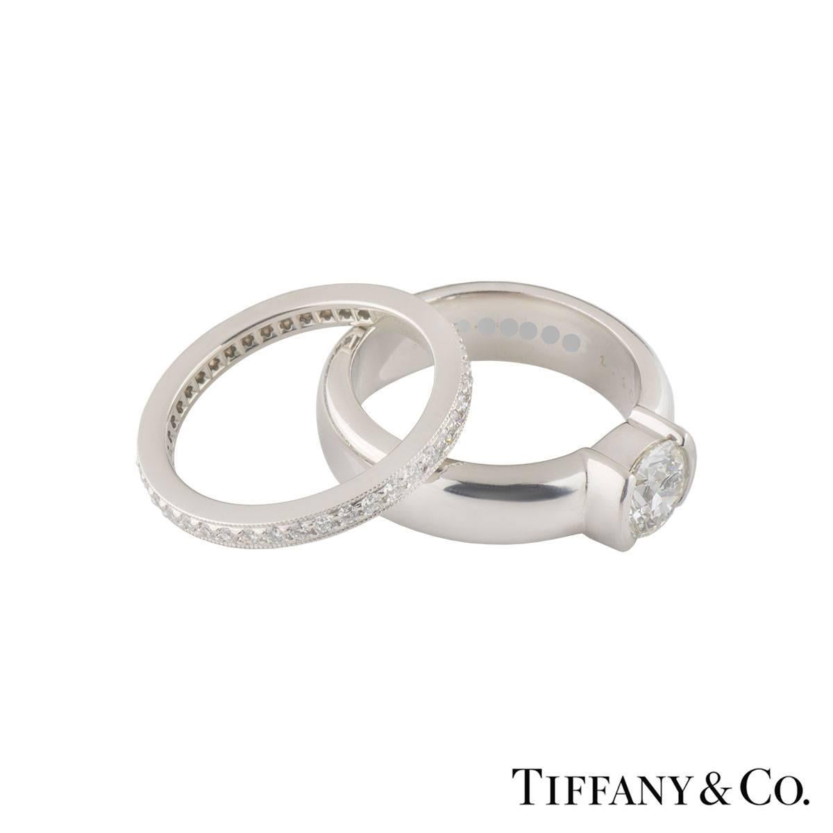 A beautiful diamond set full eternity Tiffany & Co. ring in platinum from the Legacy collection and a sparkly diamond engagement ring from the Etoile collection. The engagement ring comprises of a round brilliant cut diamond in a rubover setting