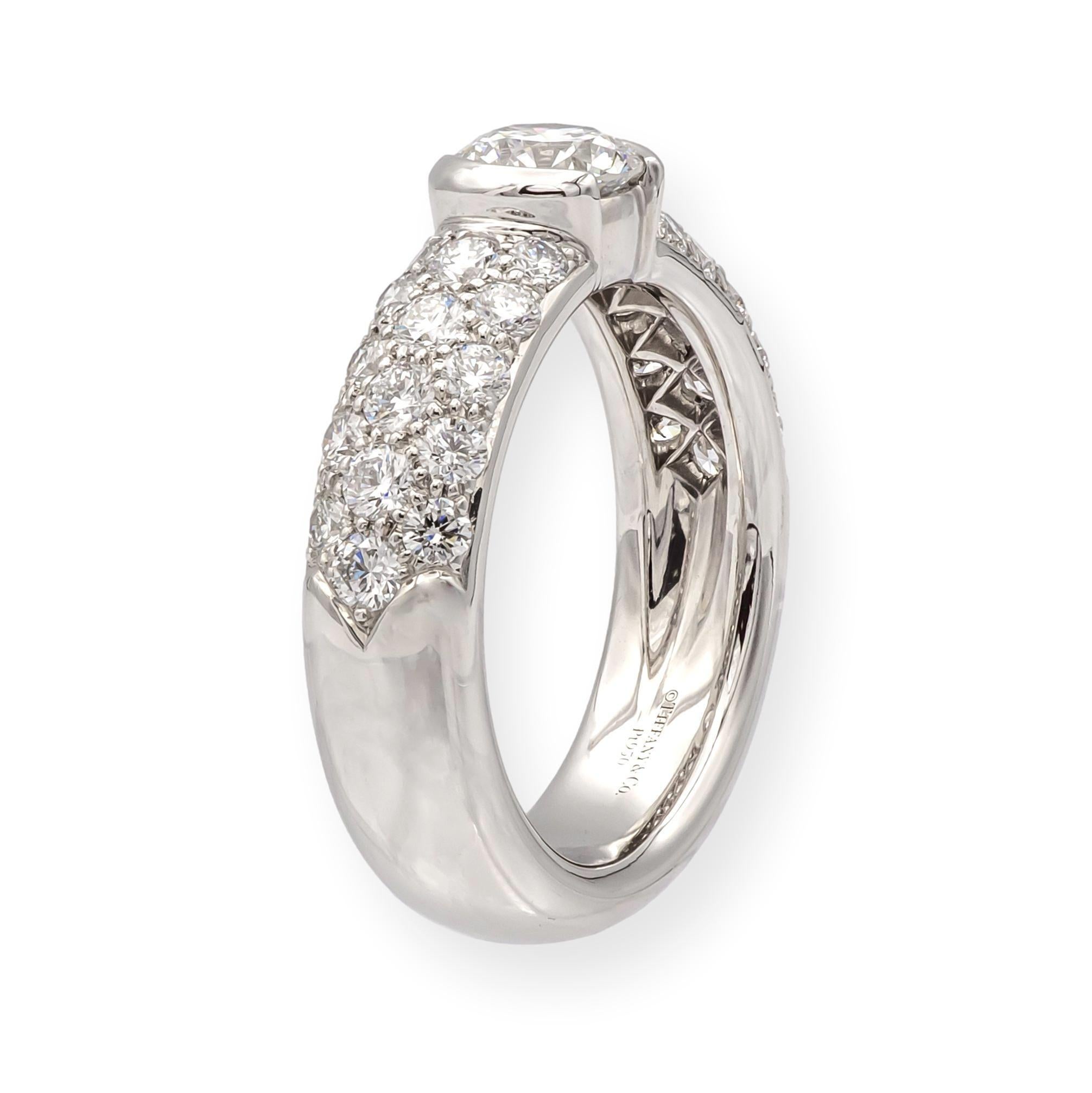A discontinued and highly sought-after design from Tiffany & Co.'s iconic Etoile Collection, this platinum ring features a 0.49ct round brilliant center diamond (H color, VS1 clarity) in a sleek partial bezel setting. The shoulders of the band are