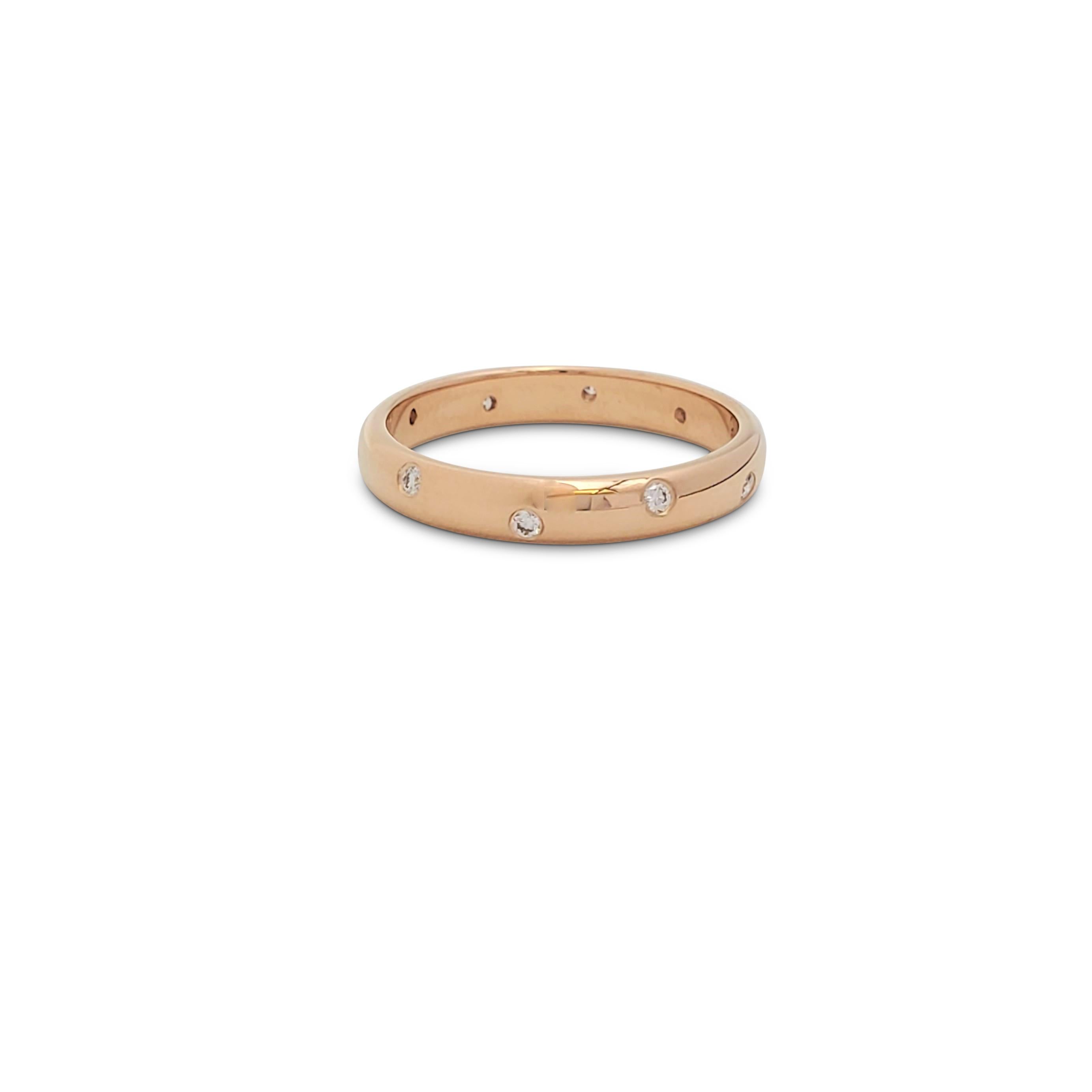 Authentic Tiffany & Co. 'Etoile' band ring crafted in 18 karat rose gold features bezel set round brilliant cut diamonds weighing an estimated 0.13 carats total weight (E-F, VS). Ring size 6. Signed T&Co., Au750. The ring is presented with the
