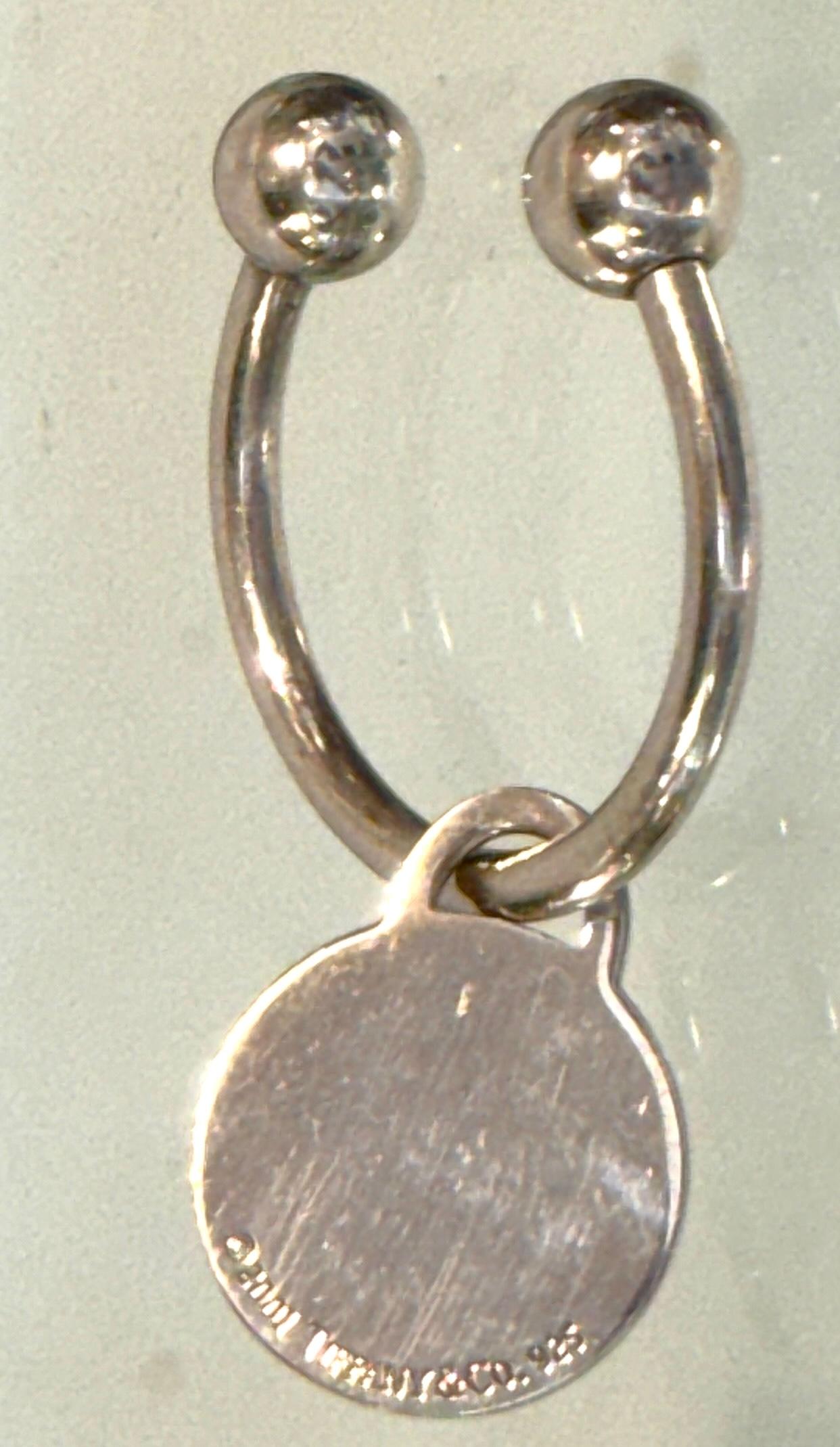 Tiffany & Co. Extra Large Sterling Silver Round Tag Screwball Key Ring, Dated 2001

Dimensions: 2.5