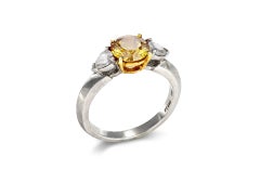 Tiffany & Co Fancy deep orange-yellow diamond flanked solitaire ring, American.