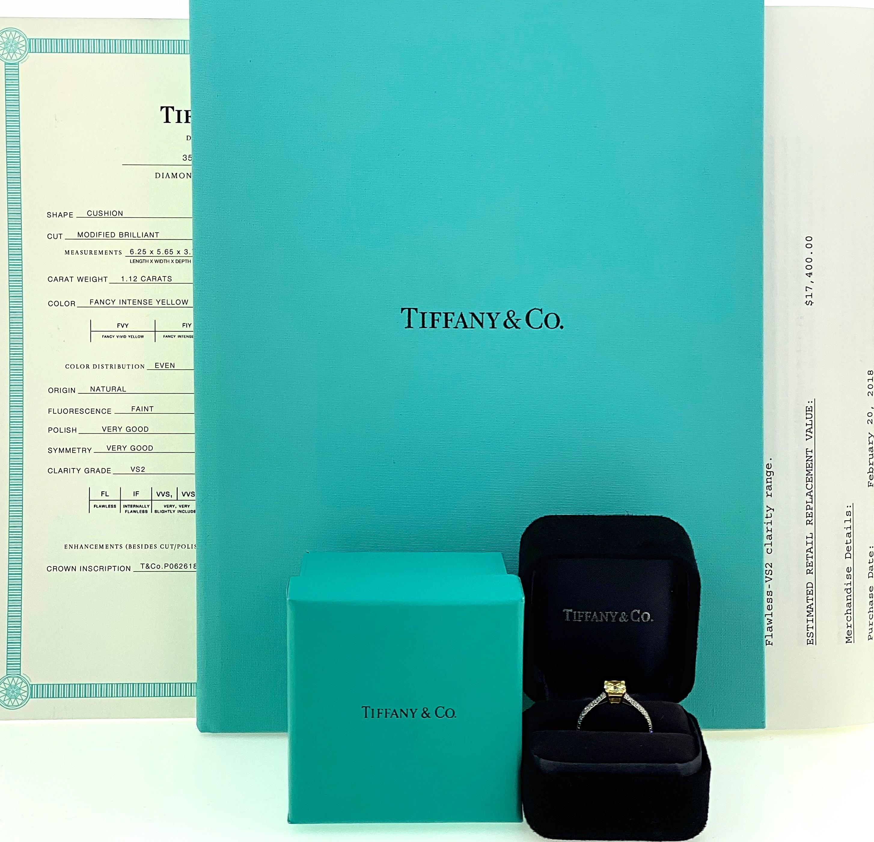 Tiffany & Co Novo Fancy Intense Yellow Diamond Engagement Ring
Style:  Solitaire with Accents
T&C Diamond Certificate:  35790357/P06261829
Metal:  Platinum PT950
Size:  6.75 sizable
TCW:  1.28 tcw
Main Diamond:  Cushion Modified Brilliant Diamond