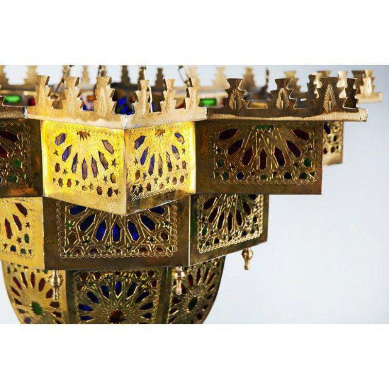 
 The Vintage Moroccan brass and colored glass brass star shaped chandelier features individually wrought multicolored glass panes and elaborate design.  The handmade chandelier is  a stylish and unique addition to your living room or hallway and