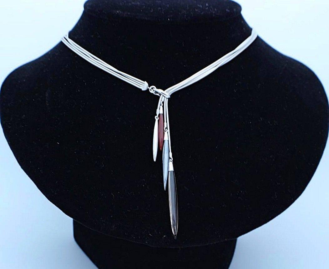 Tiffany & Co.
Style:  Feather Collection Lariat 4 Strand Necklace 
Gemstones:  Lucite - Hematite - Agate
Metal:  18KT White Gold
Length:  16 Inches  
Hallmark:  ©T&Co.750
Includes:  T&C Necklace Box

Retail Value:  $3,000 + tax =