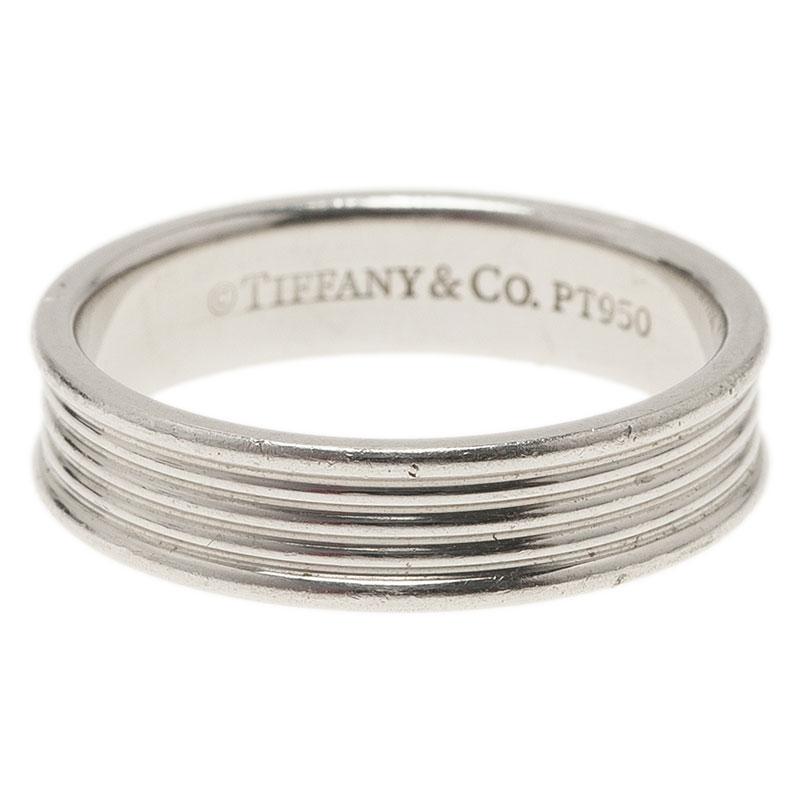 Strengthen your bond of love with this sleek and classy wedding band from the house of Tiffany & Co. Made from solid platinum, this band is designed in a slick five row pattern. It comes stamped with brand name and adds a touch of class to almost