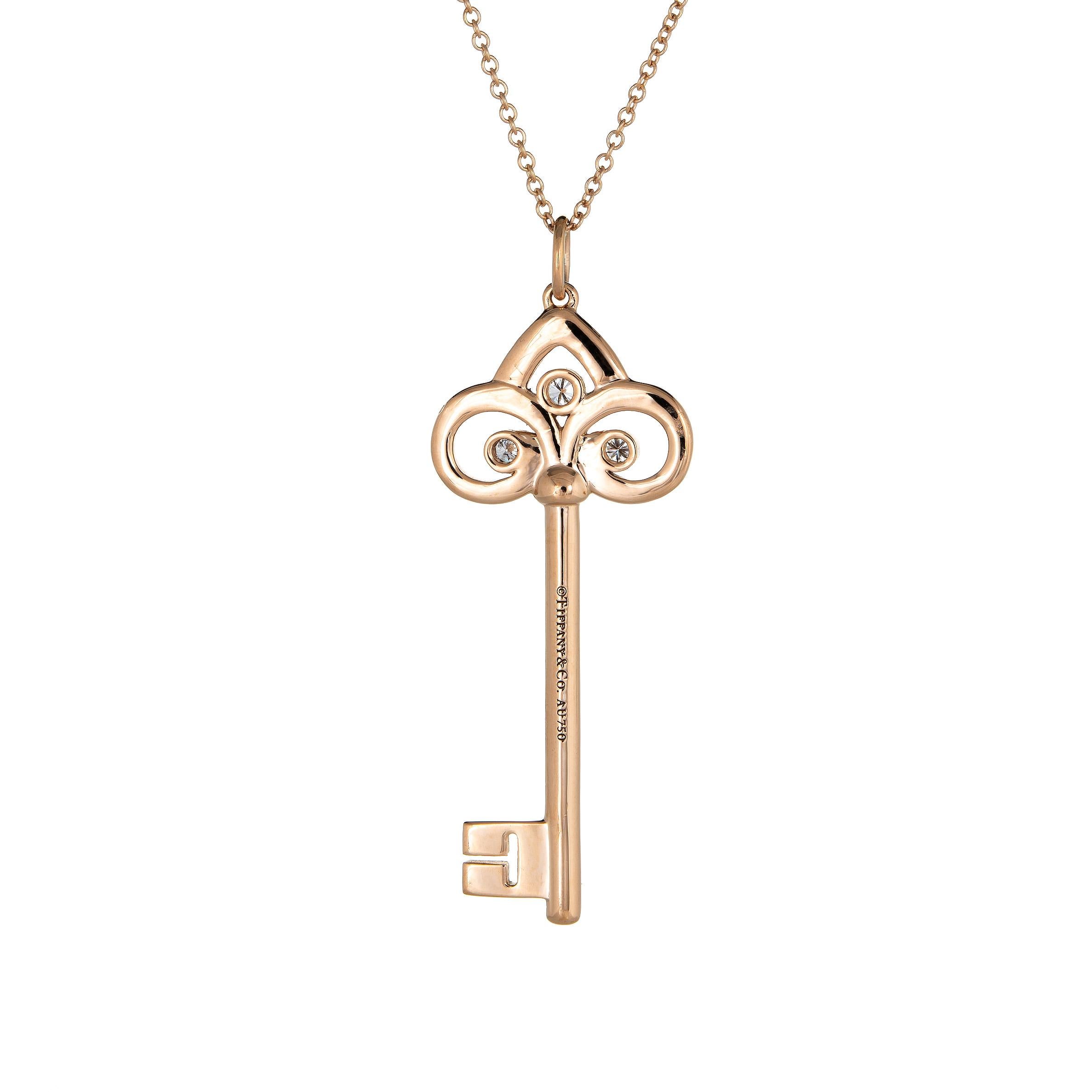 Elegant and finely detailed estate Tiffany & Co medium Fleur de Lis diamond key pendant & necklace crafted in 18 karat rose gold.  

Diamonds total 0.07 carats (estimated at F-G color and VVS2 clarity). 

The key measures 1 1/2 inches in length and