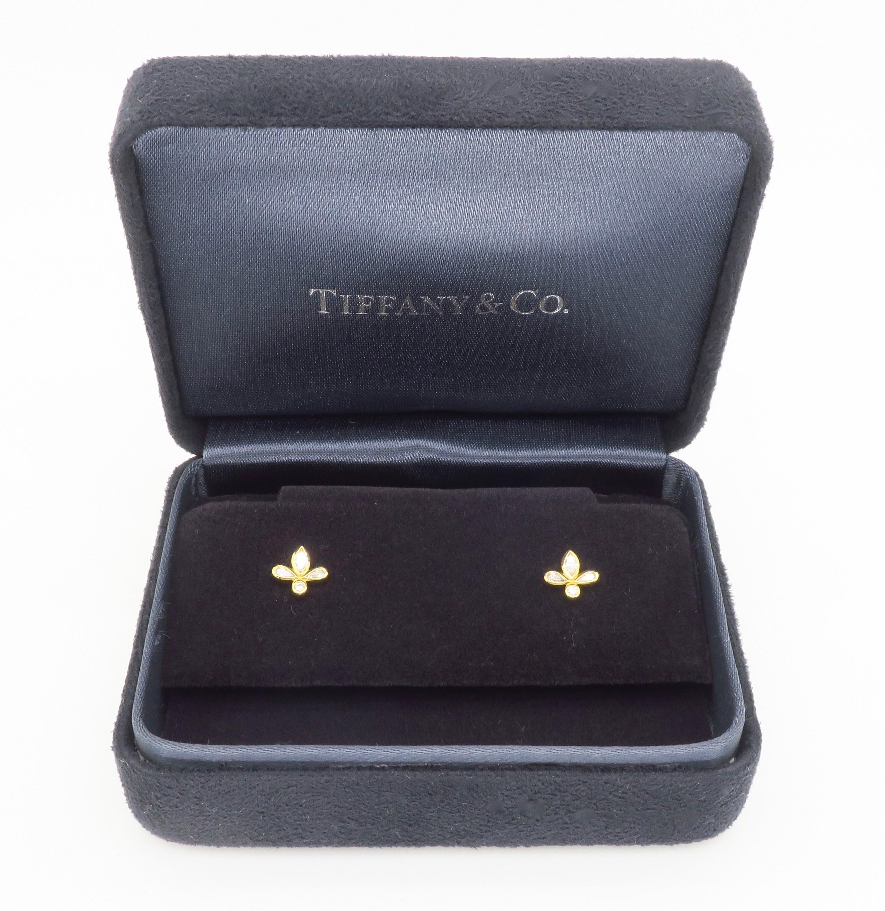 Authentic Tiffany & Co. Fleur de Lis Diamonds stud earrings in 18k, with original box. 

Diamond Carat Weight: .19CTW
Diamond Cut: Marquise, Pear and Round Brilliant
Color: E-F
Clarity: VS1-VS2
Metal: 18k Yellow Gold
Marked/Tested: Stamped “T & CO