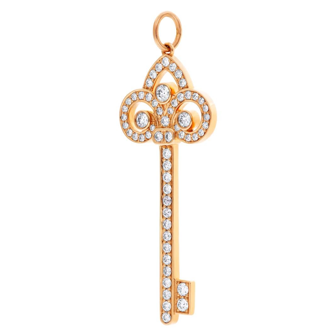 Tiffany & Co. Fleur de Lis key pendant in 18k rose gold with diamonds on custom beaded 14k rose gold chain. Key measures 1.5 inches in length. Chain length 16 inches.
