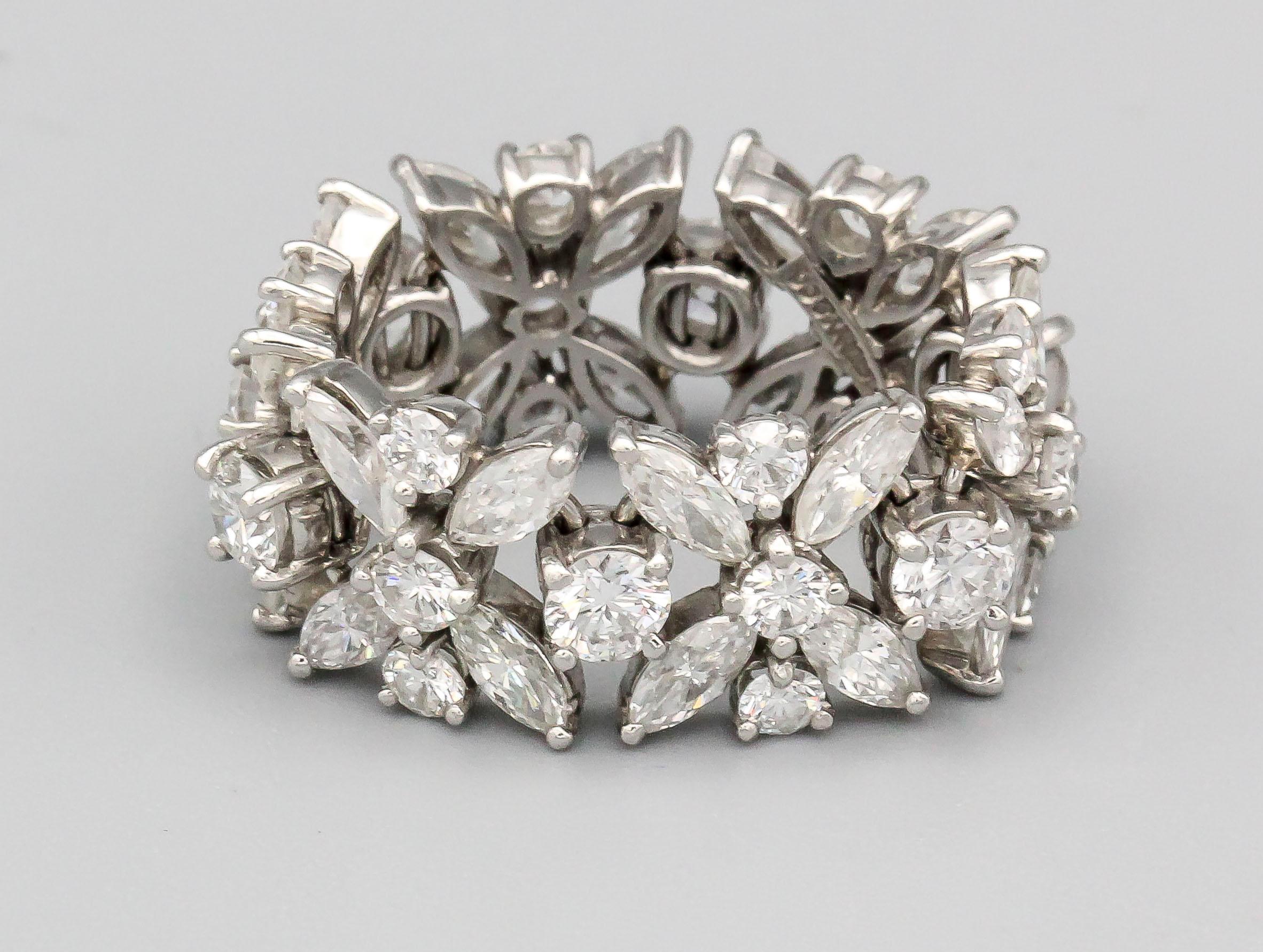 Fine platinum and diamond band by Tiffany & Co., circa 1970s. It features high grade round brilliant cut diamonds and marquise cut diamonds, approx. 5.0 carats of G-H color and VS clarity, set in a beautifully intricate flexible design. Size