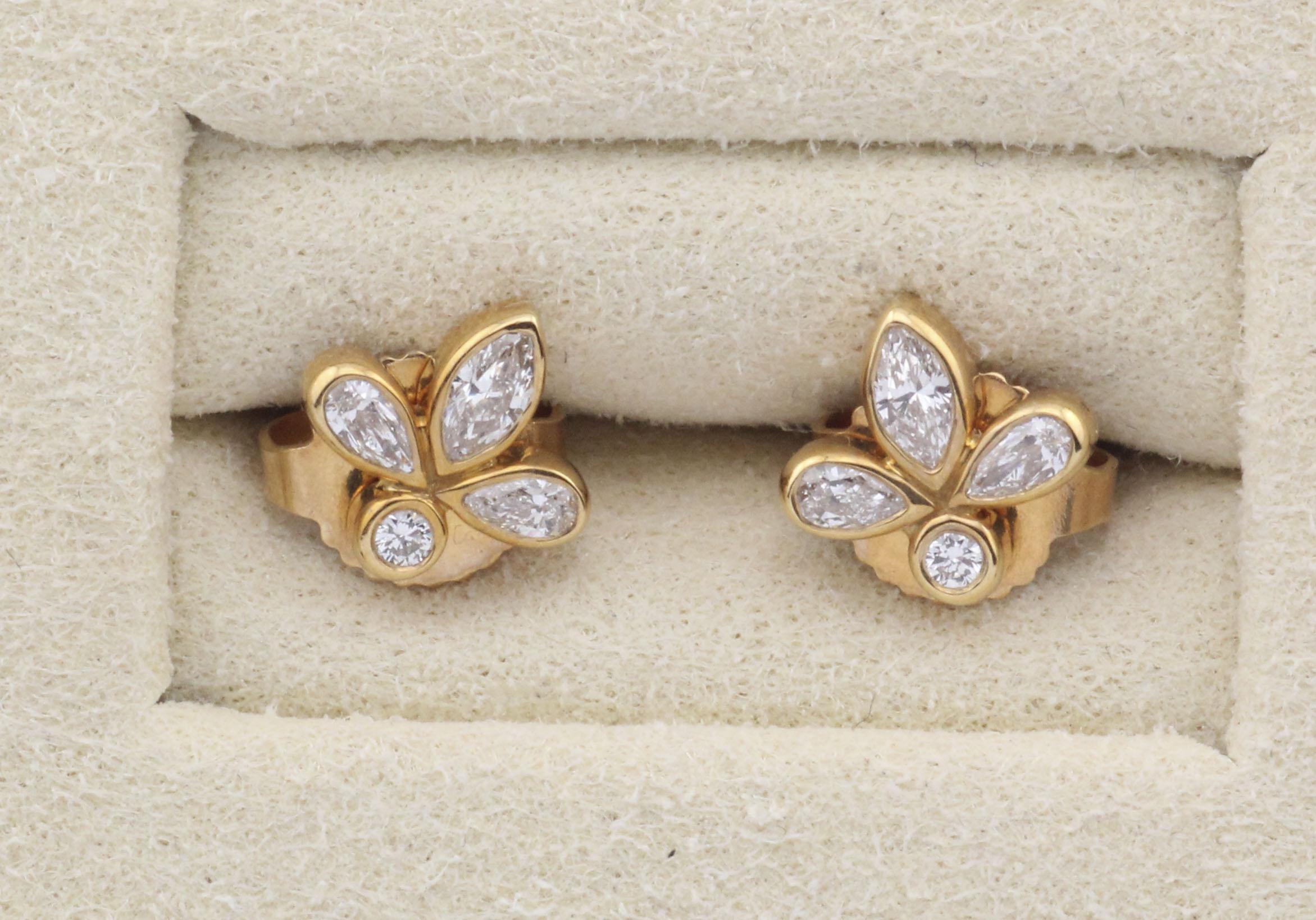 Discover the elegance of Tiffany & Co. with these exquisite 18k Yellow Gold Stud Earrings. Crafted with precision, these earrings embody timeless luxury.

Each earring features a cluster of white diamonds, artfully arranged in a floral motif. The