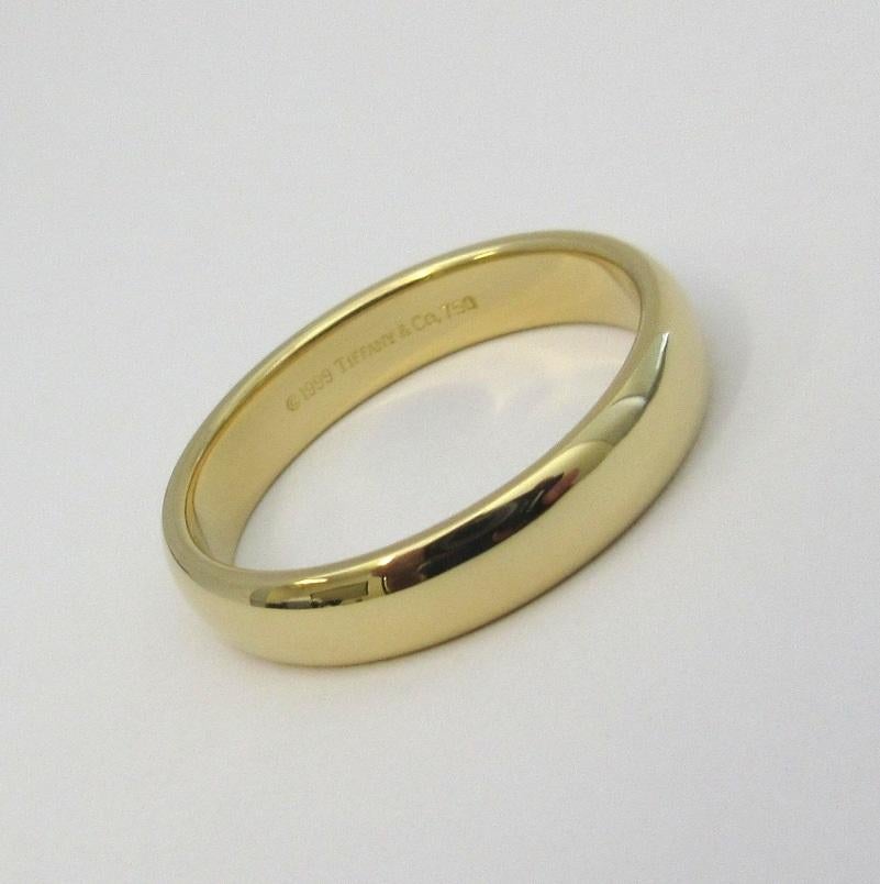 TIFFANY & Co. Forever 18K Yellow Gold 4.5mm Lucida Wedding Band Ring 10 

Metal: 18K Yellow Gold
Size: 10 
Band Width: 4.5mm
Weight: 7.20 grams
Hallmark: ©1999 TIFFANY&Co. 750
Condition: Excellent condition, like new

Authenticity guaranteed