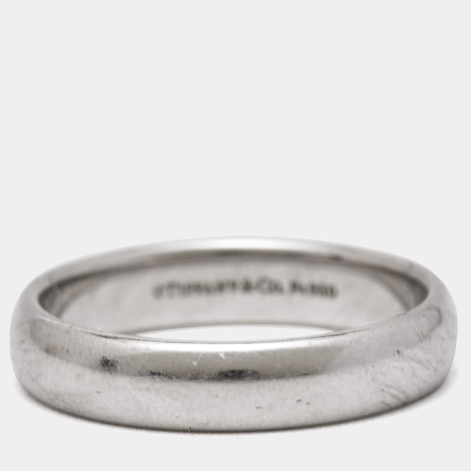 The Tiffany & Co. Forever wedding ring is a symbol of everlasting love and commitment. Crafted from lustrous platinum, it features a timeless design with a smooth surface and a comfortable fit. This elegant ring exudes sophistication and is a